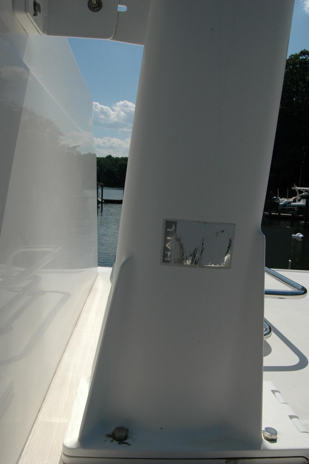 2006 Sabre 36 Flybridge Sedan boat detail with water and dock in background.
