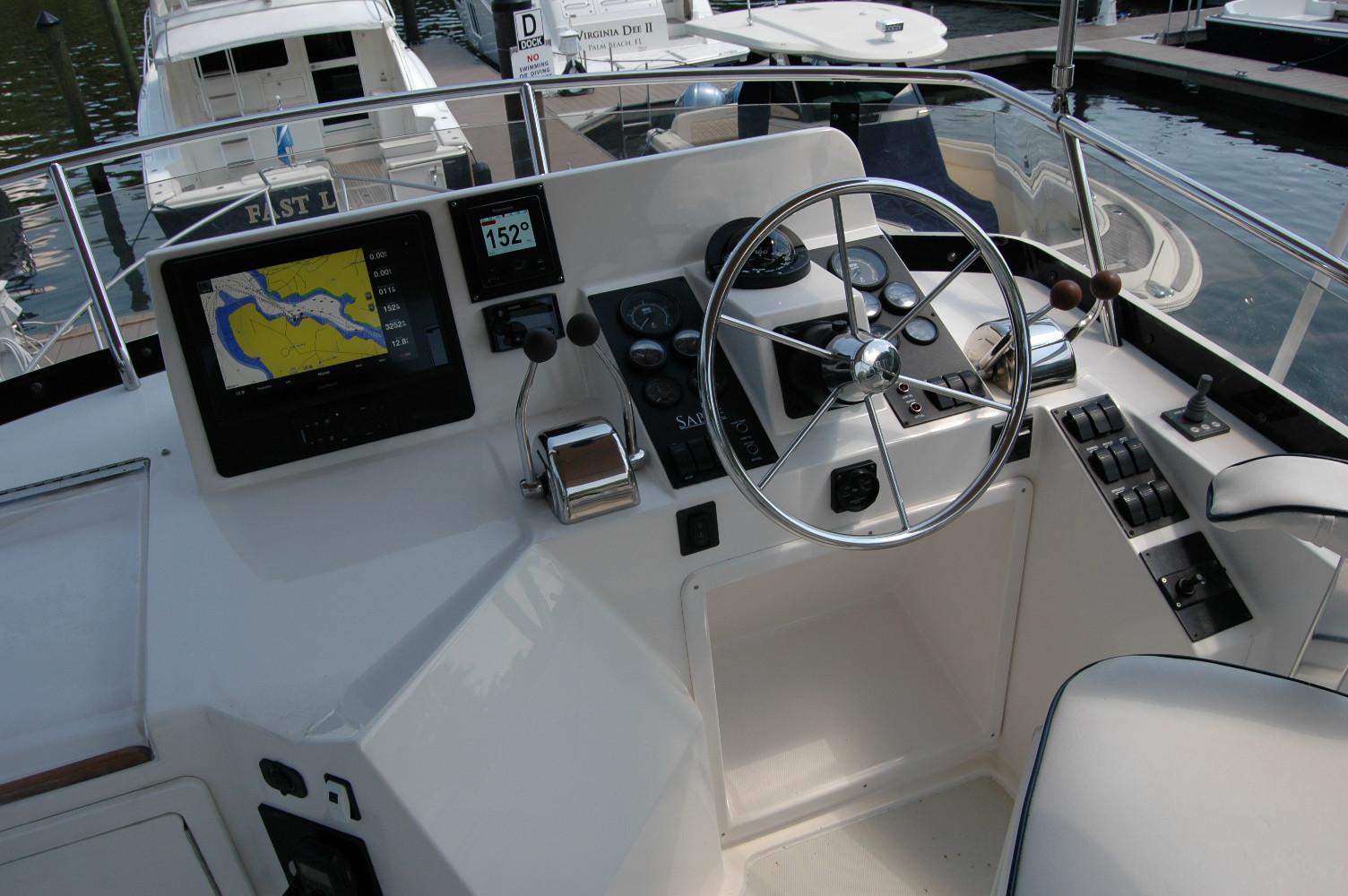 2006 Sabre 36 Flybridge Sedan helm with navigation display and steering wheel.