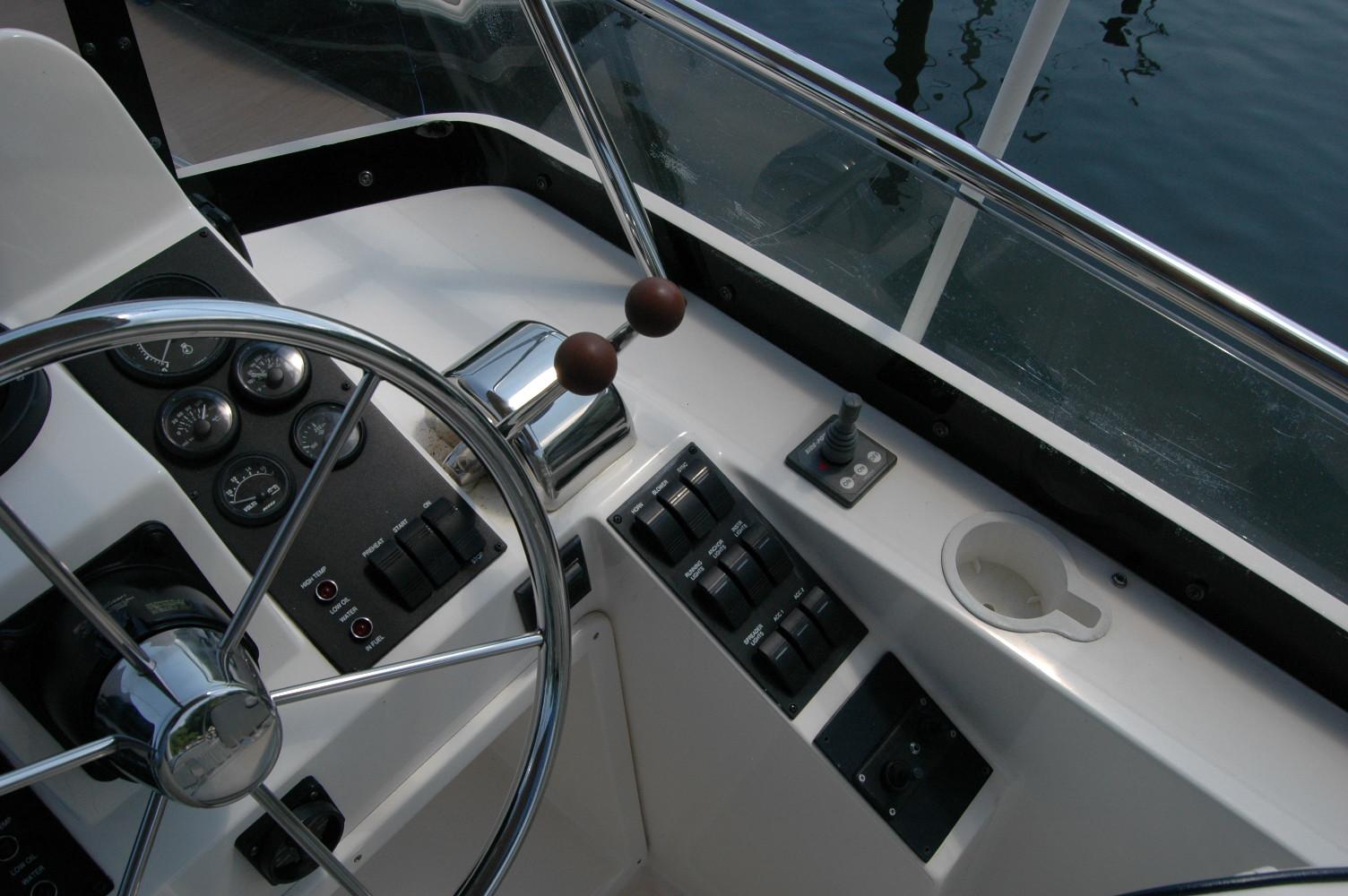 Helm of 2006 Sabre 36 Flybridge Sedan with steering wheel and control panel.