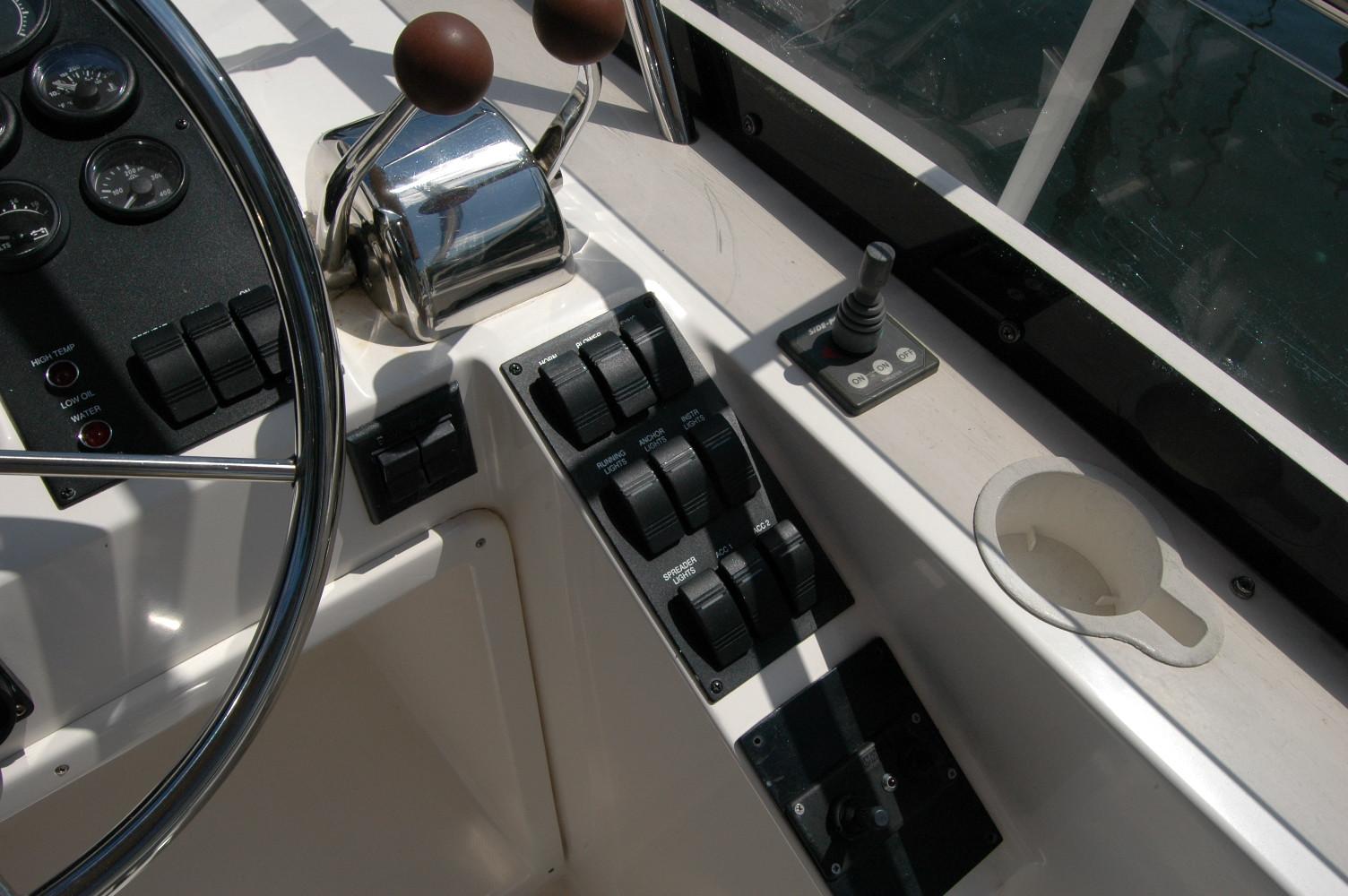 Control panel of 2006 Sabre 36 Flybridge Sedan with steering wheel and throttle levers.