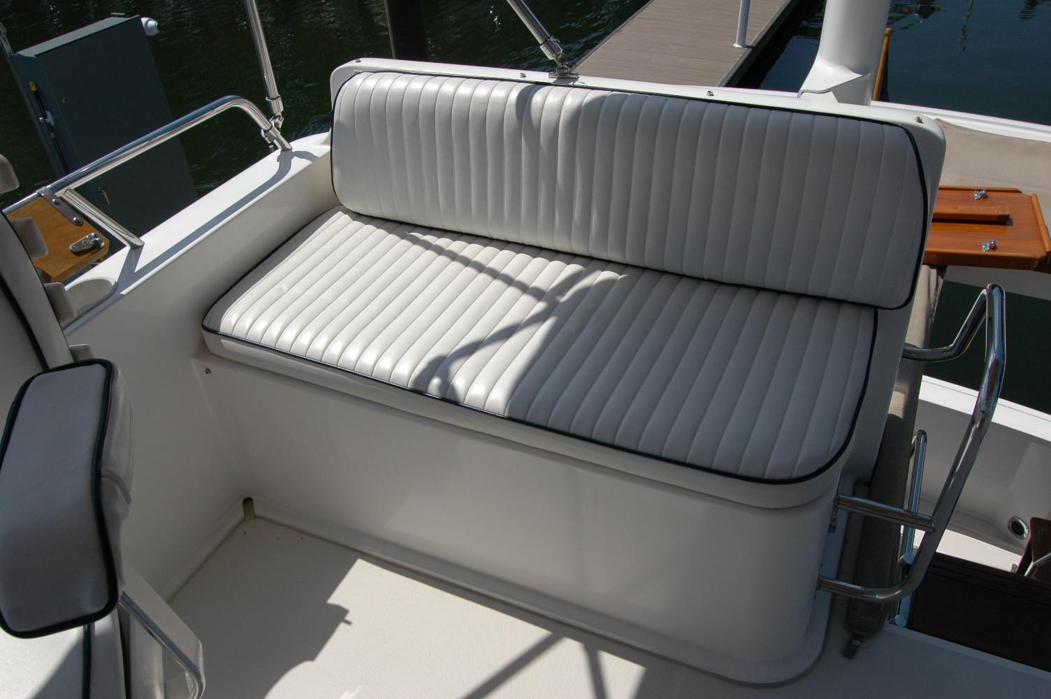 White cushioned seating on 2006 Sabre 36 Flybridge Sedan boat deck.