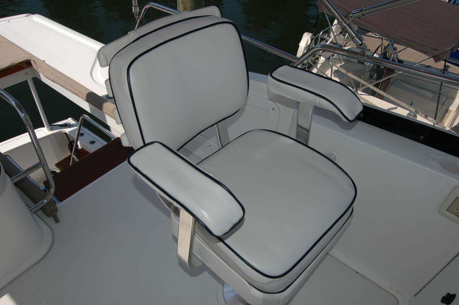 Captainu0027s chair on 2006 Sabre 36 Flybridge Sedan, featuring white upholstery with black trim.