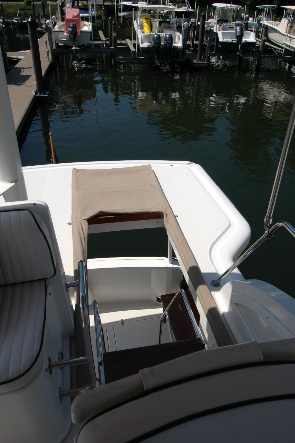 2006 Sabre 36 Flybridge Sedan at marina, showcasing deck and seating area.
