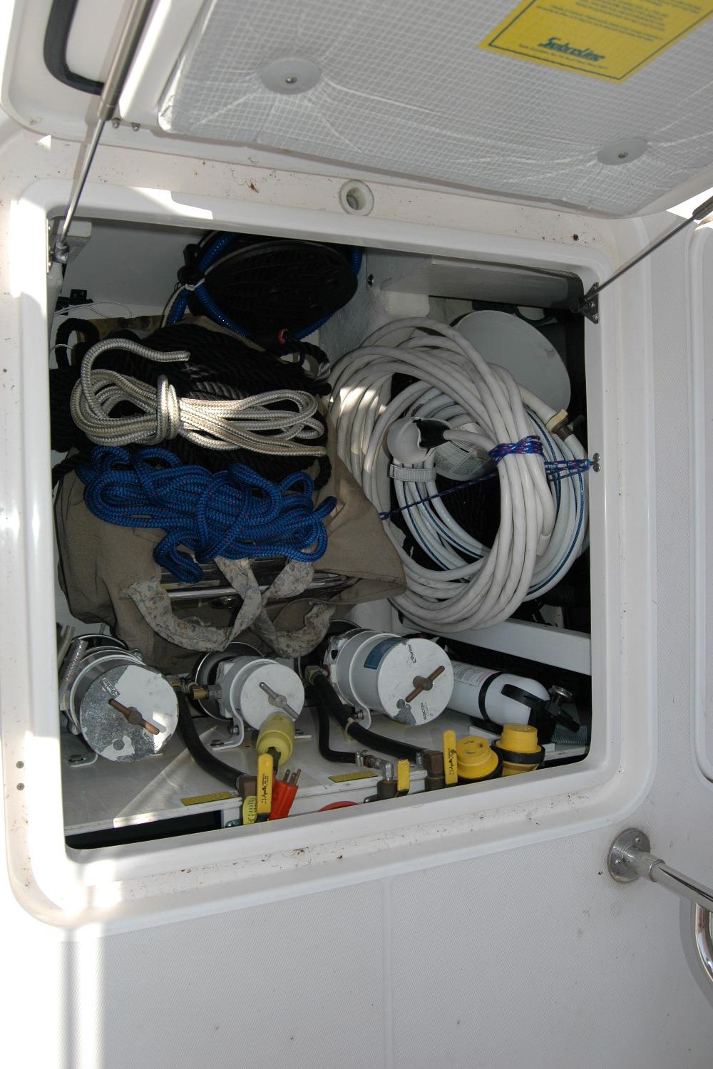 Storage compartment on a 2006 Sabre 36 Flybridge Sedan with ropes and equipment.