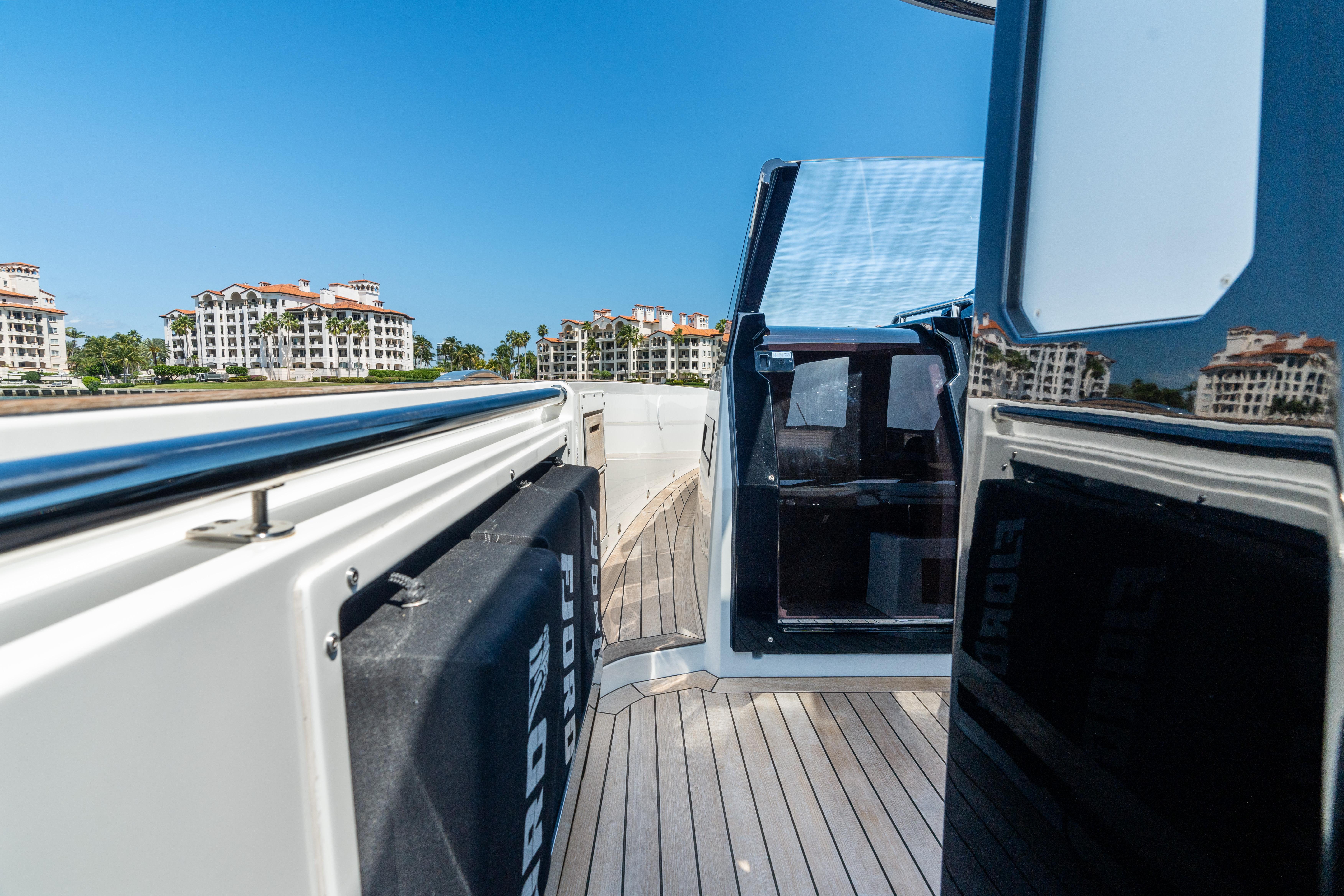 Fjord-44 Open 2022-HINJUICE FL-US-2022 Fjord 44 Open yacht with sleek deck and modern design, docked near luxury buildings.-9860902 | Thumbnail