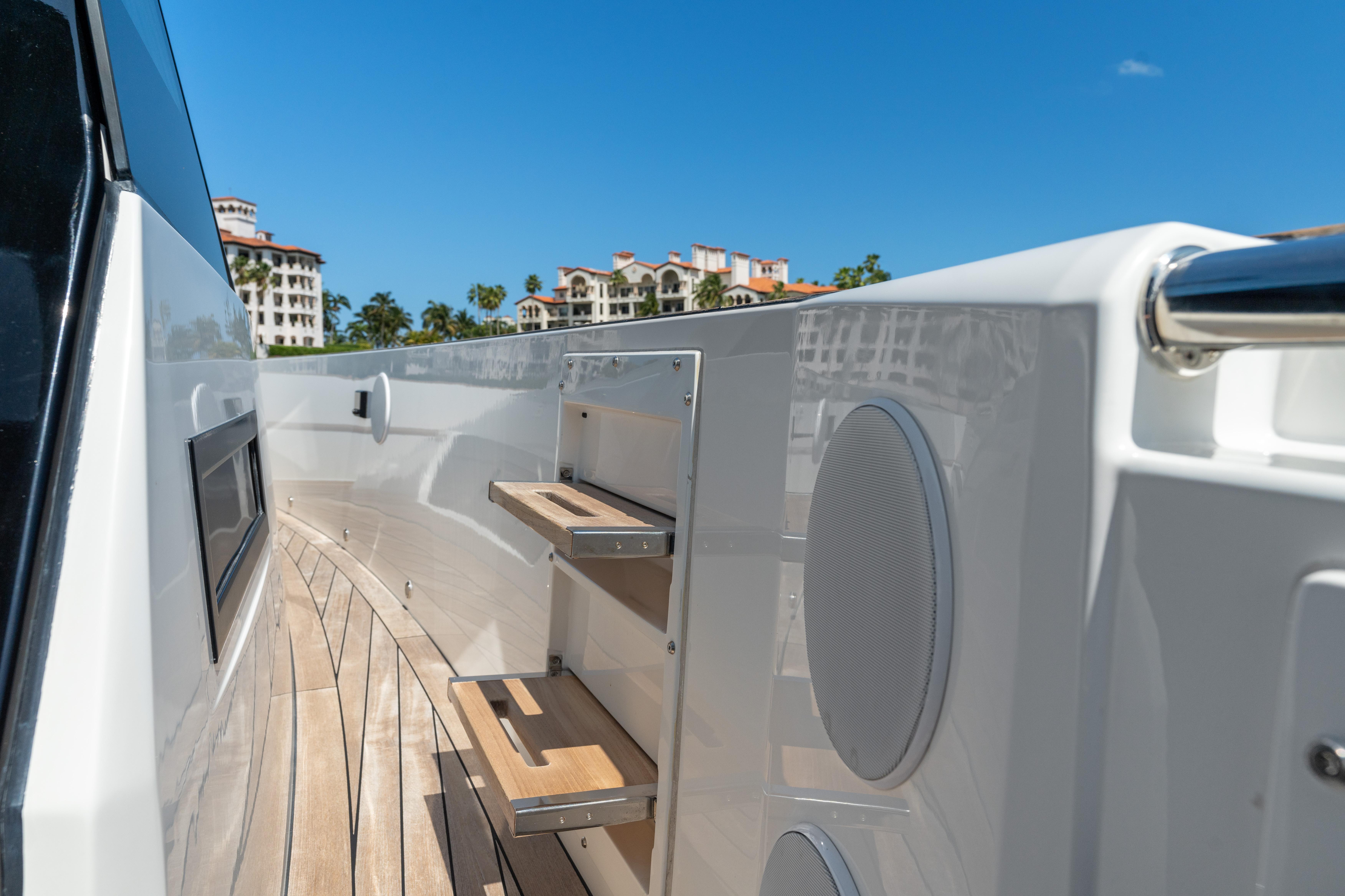 Fjord-44 Open 2022-HINJUICE FL-US-Fjord 44 Open 2022 yacht deck with wooden steps and speakers, under clear blue sky.-9860902 | Thumbnail