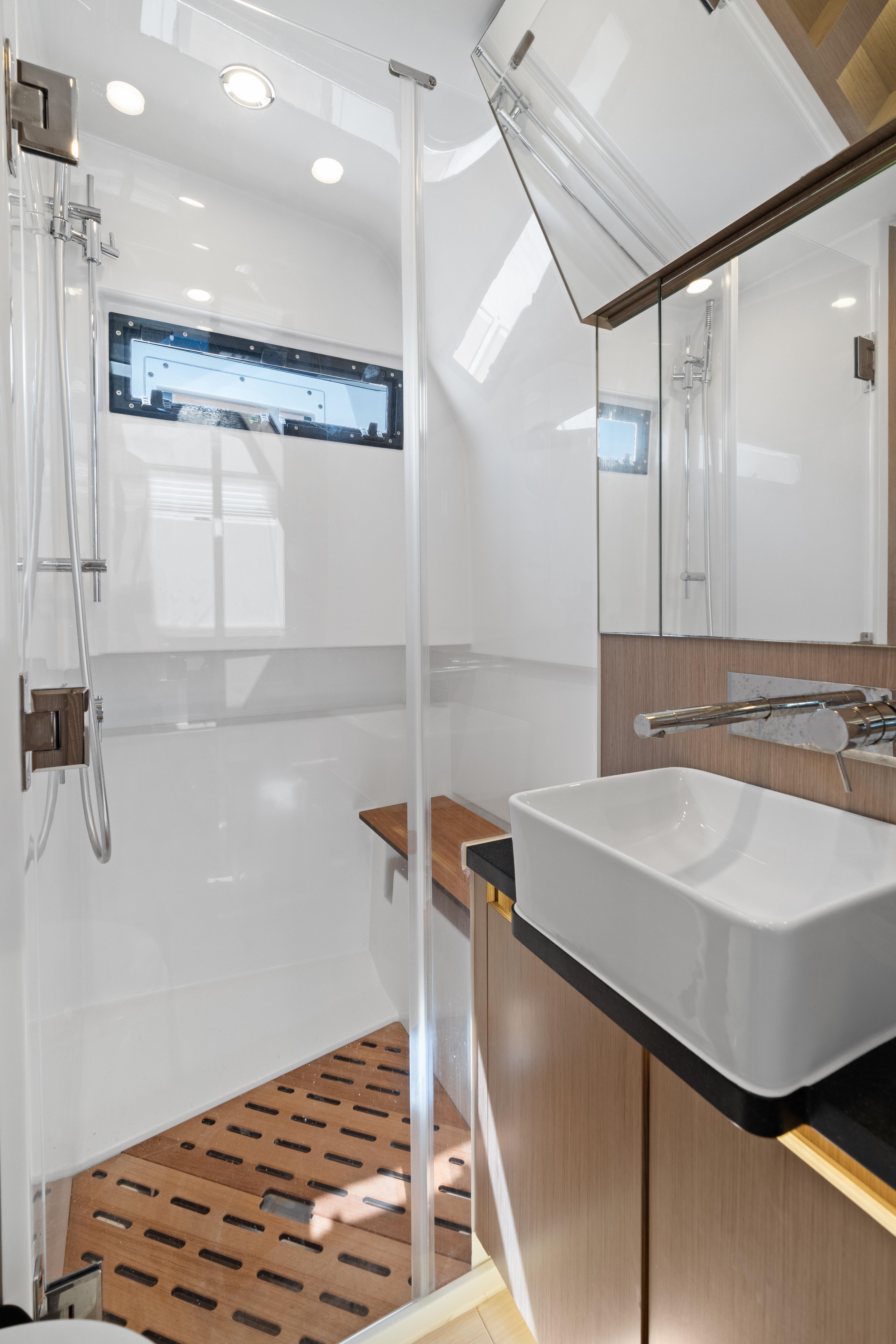 Fjord-44 Open 2022-HINJUICE FL-US-Modern bathroom interior of 2022 Fjord 44 Open yacht with sleek design and wooden accents.-9860902 | Thumbnail
