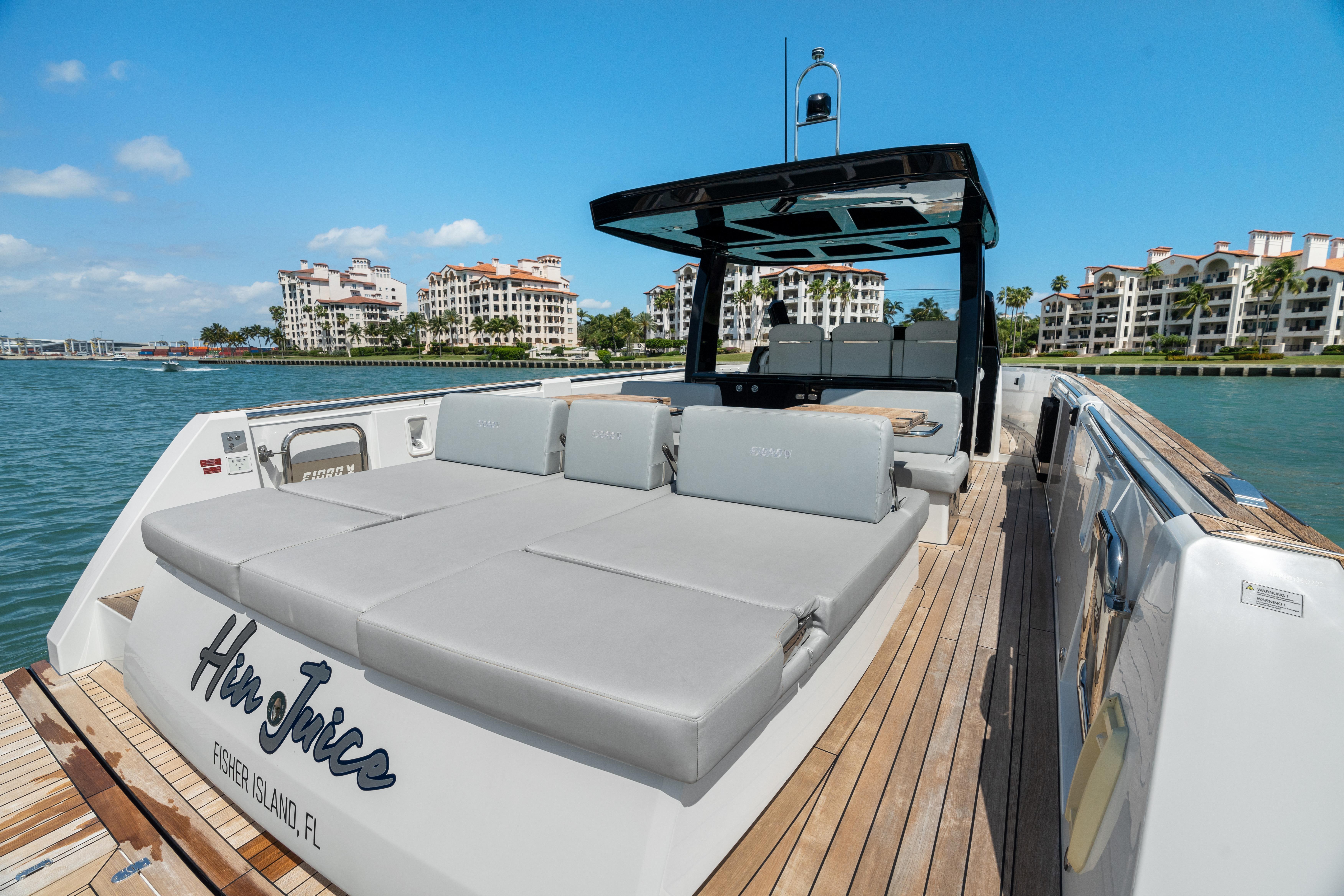 Fjord-44 Open 2022-HINJUICE FL-US-2022 Fjord 44 Open yacht with sunbathing area, docked near luxury waterfront residences.-9860902 | Thumbnail