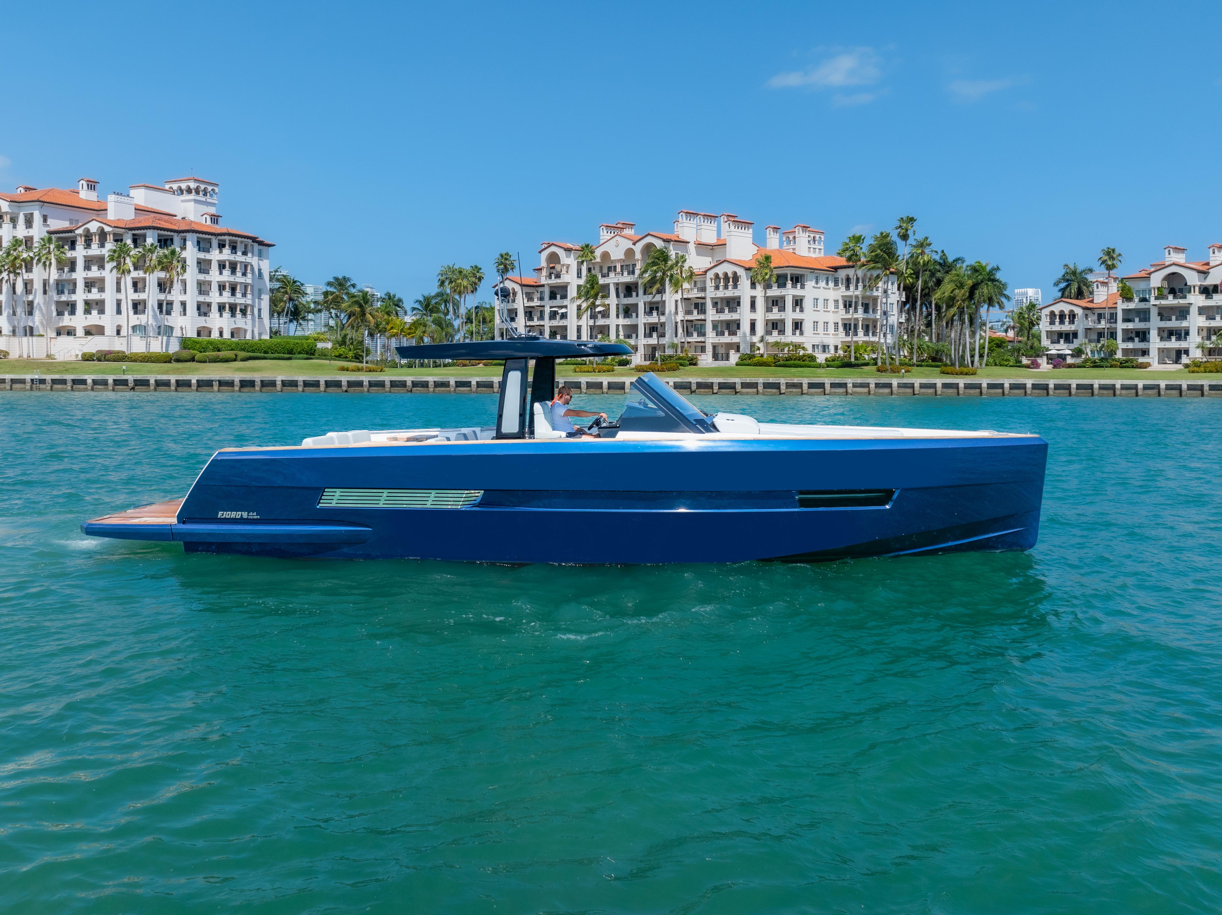 Fjord-44 Open 2022-HINJUICE FL-US-2022 Fjord 44 Open yacht cruising near luxury waterfront residences.-9860902 | Thumbnail