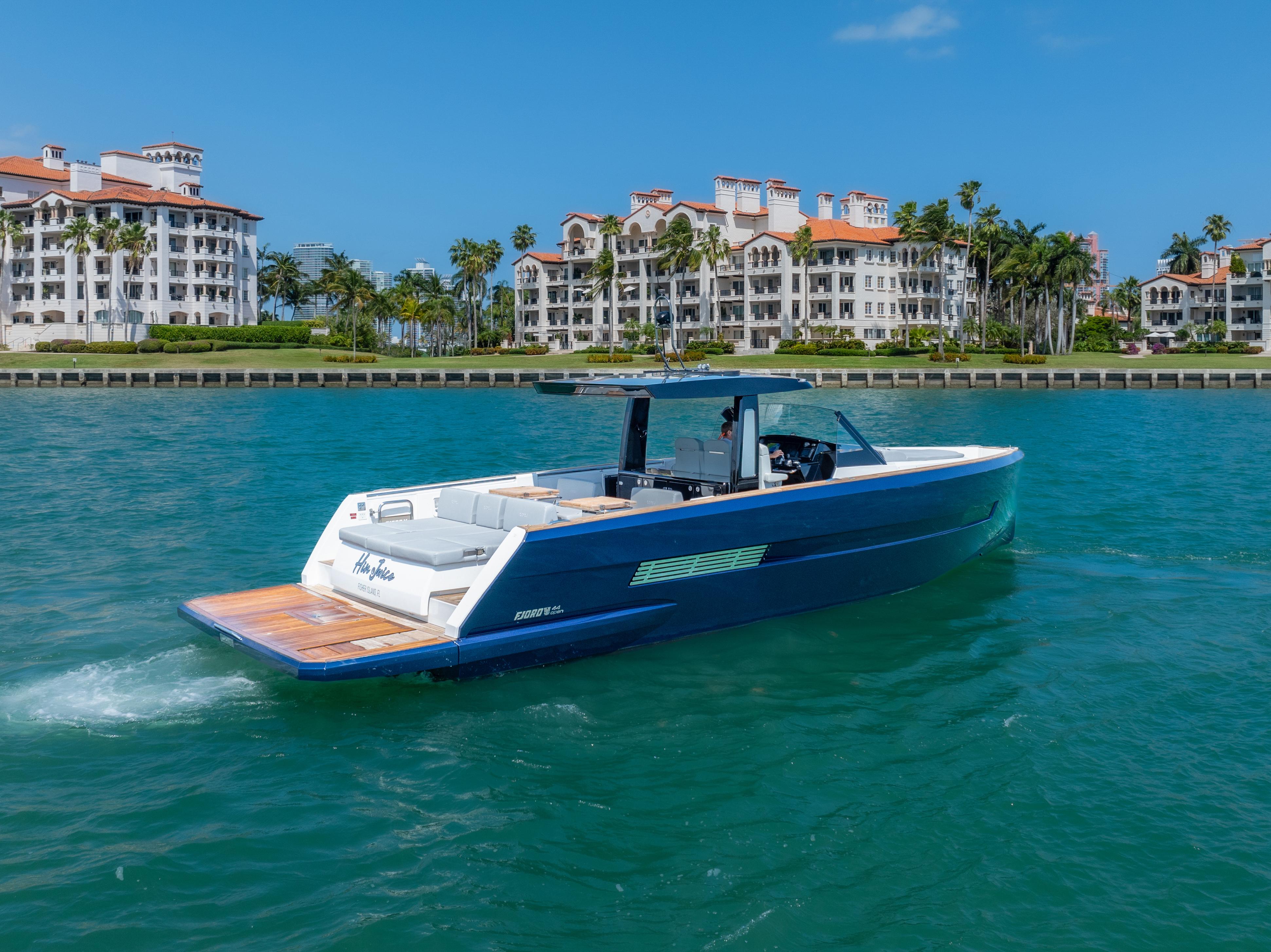 Fjord-44 Open 2022-HINJUICE FL-US-2022 Fjord 44 Open yacht cruising near luxury waterfront residences.-9860902 | Thumbnail
