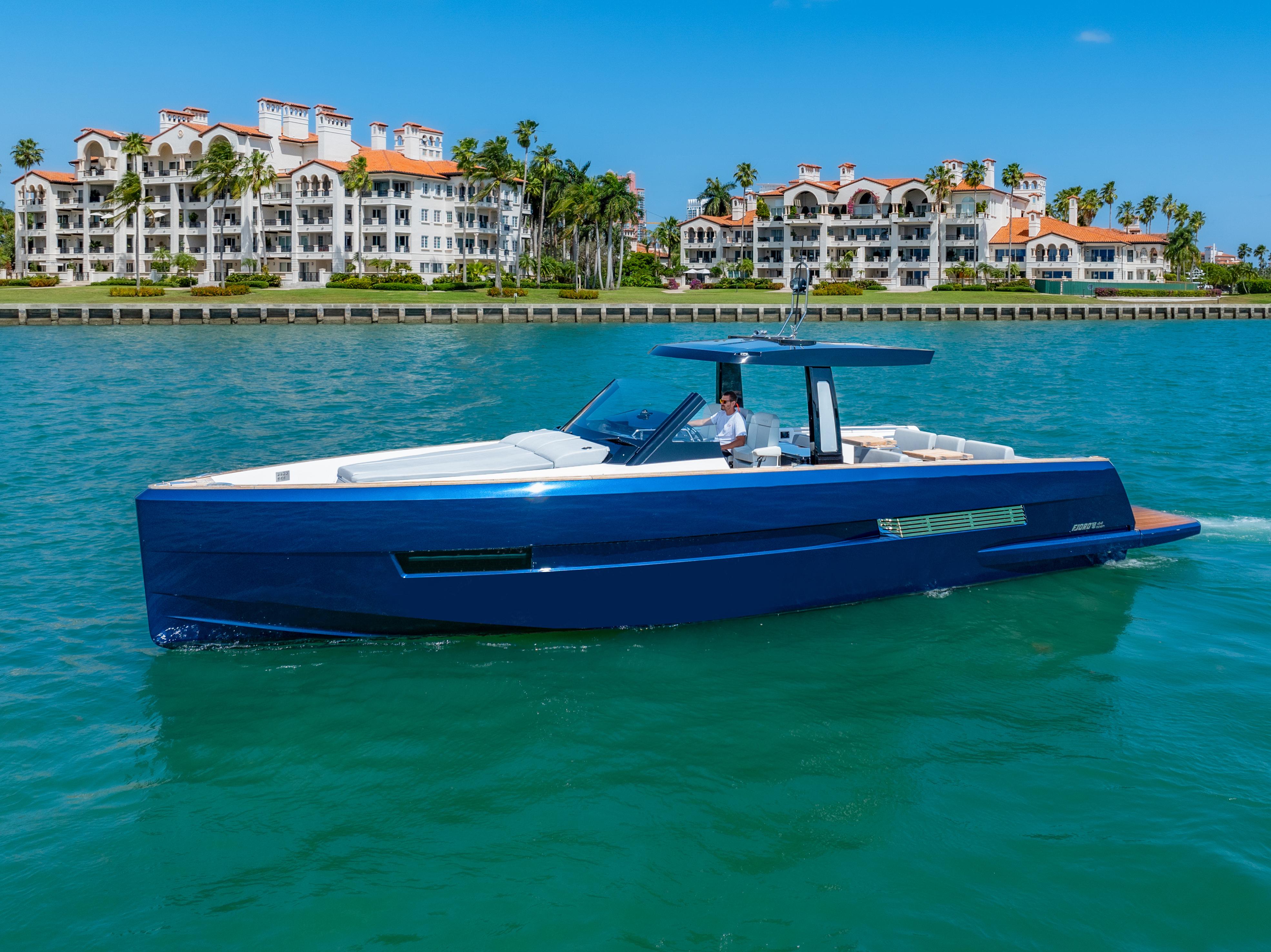 Fjord-44 Open 2022-HINJUICE FL-US-2022 Fjord 44 Open yacht cruising near luxury waterfront residences.-9860902 | Thumbnail