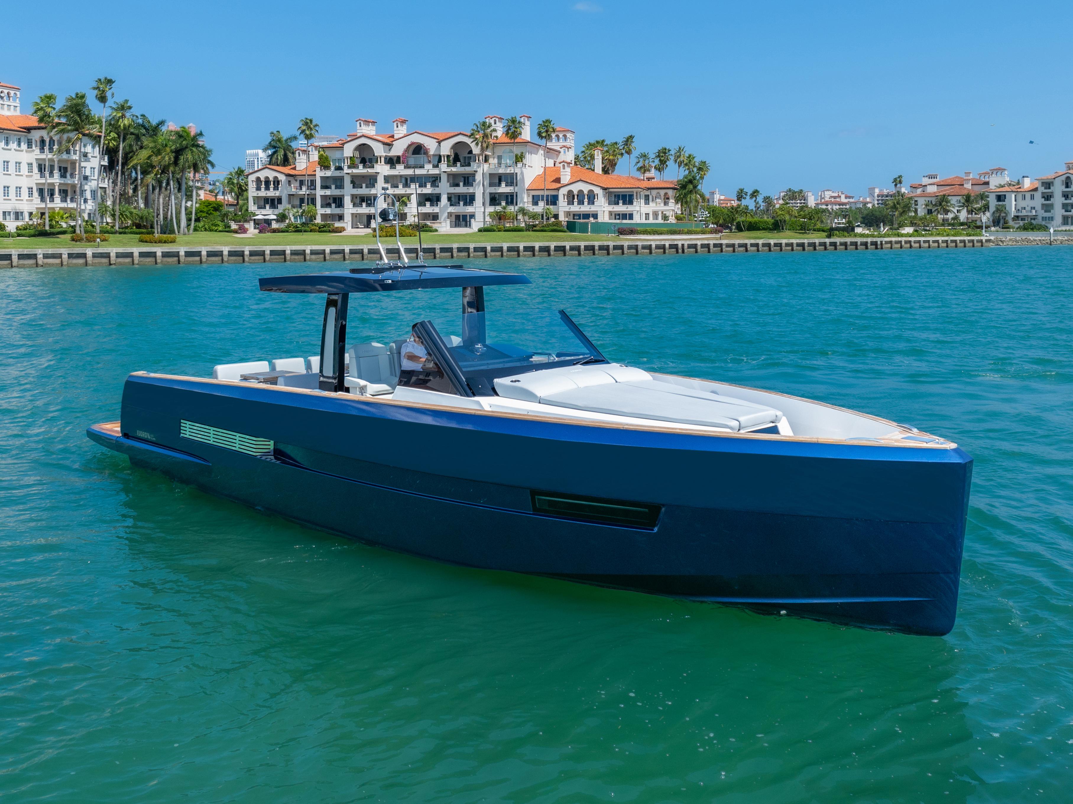 Fjord-44 Open 2022-HINJUICE FL-US-2022 Fjord 44 Open yacht cruising in turquoise waters near luxury waterfront residences.-9860902 | Thumbnail