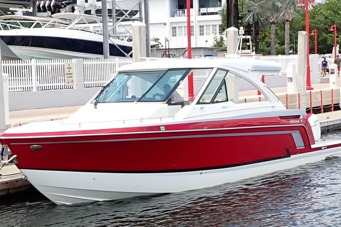 2023 Formula 380 Super Sport Crossover OB, red and white, docked at marina.