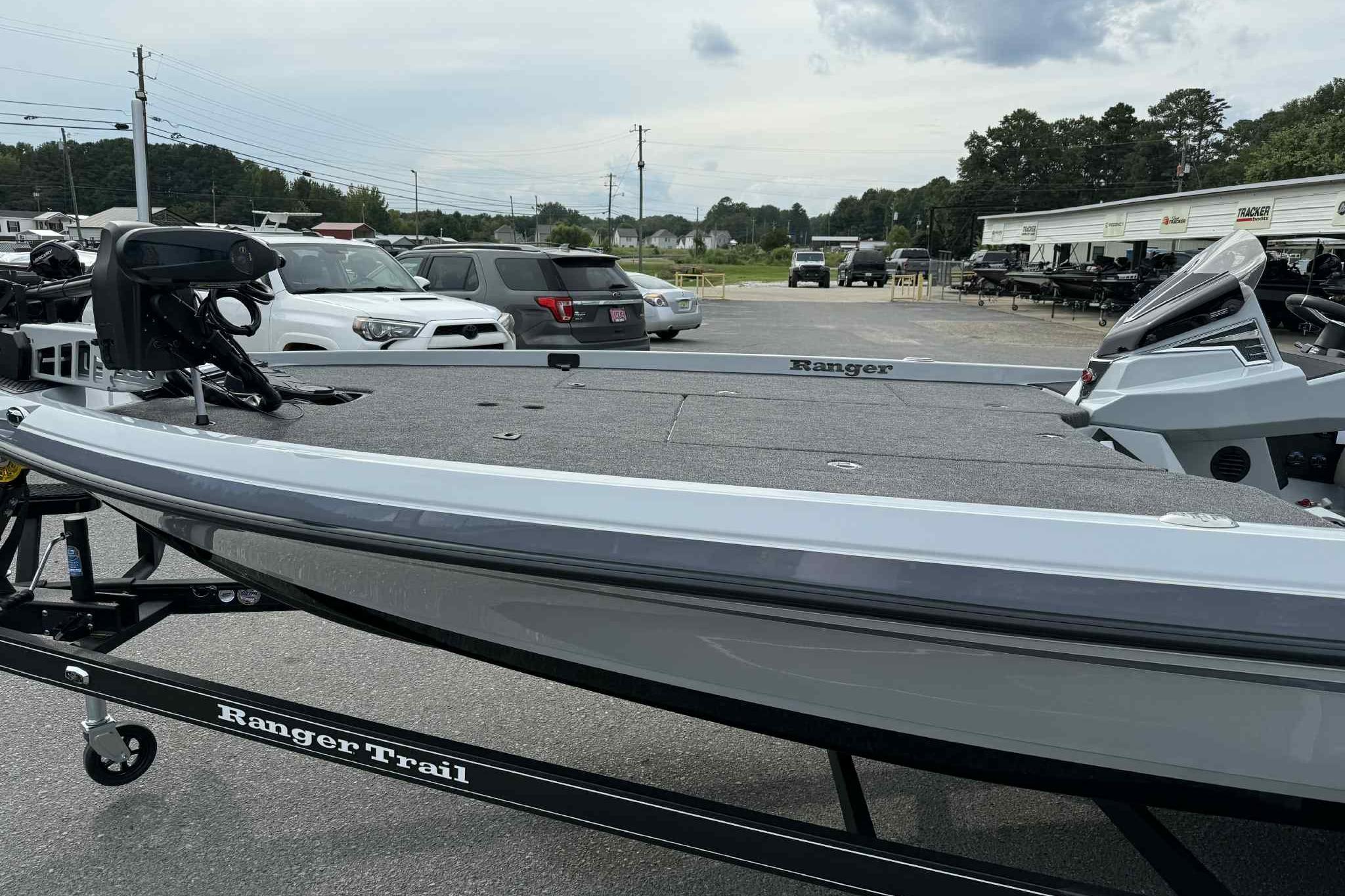 2026 Ranger Z521 boat on trailer in parking lot, surrounded by vehicles.