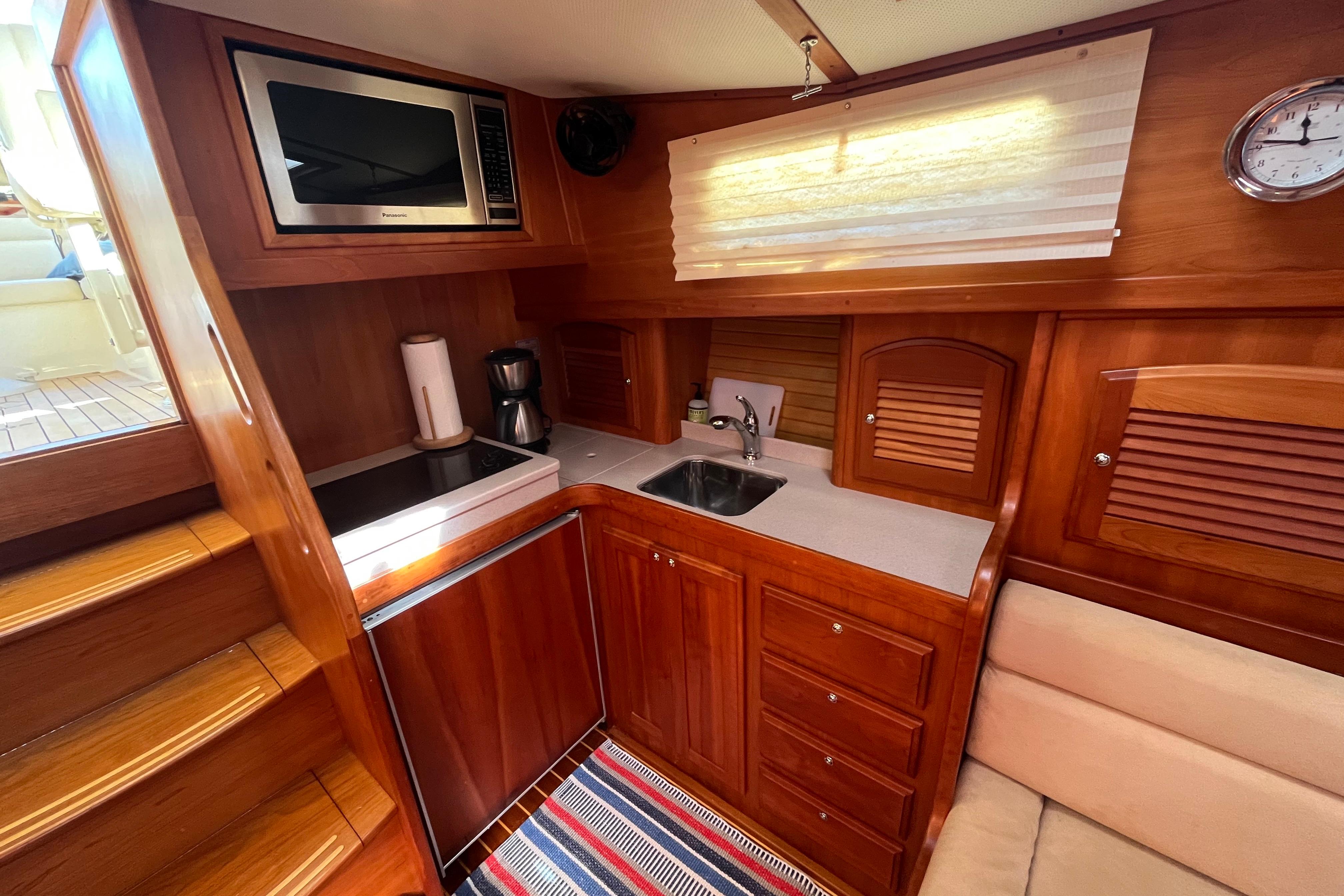 2004 Sabre 42 Hardtop Express yacht kitchen with wood cabinetry, microwave, and sink.