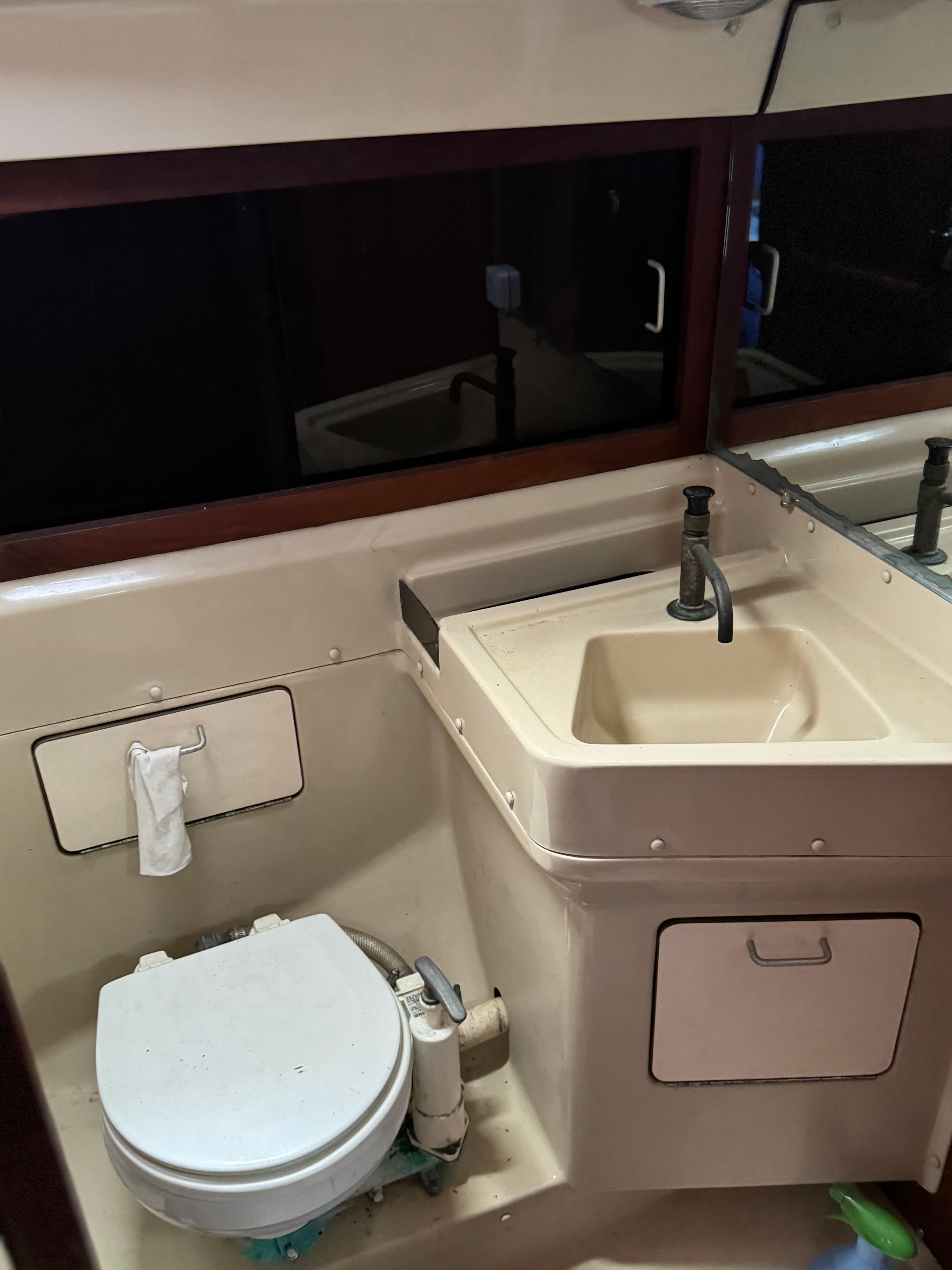 1982 O'Day 34 sailboat bathroom with sink and toilet.
