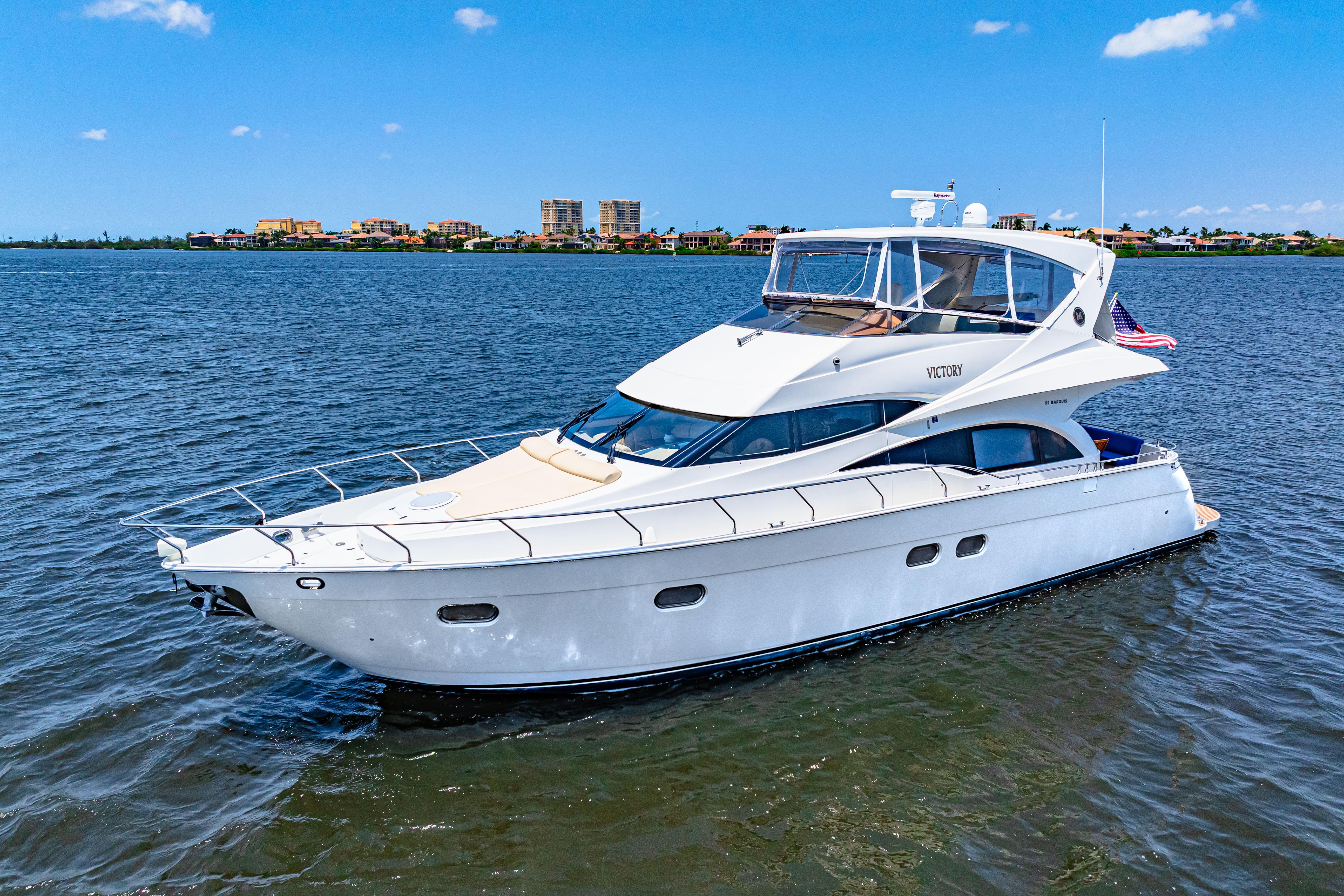 Marquis-59 2005-Victory FL-US-Luxury 2005 Marquis 59 yacht cruising on a sunny day with cityscape in background.-9773566