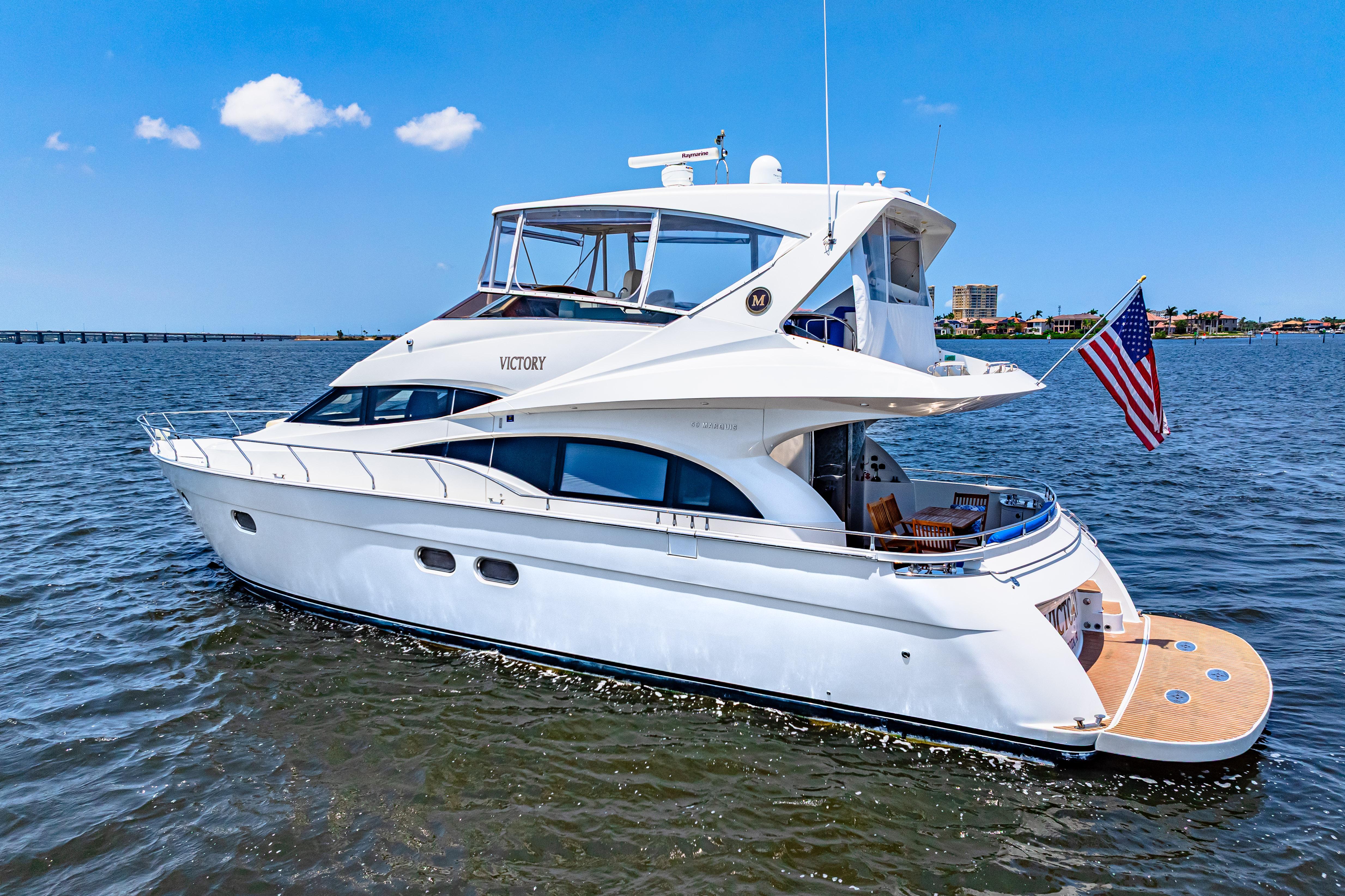 Marquis-59 2005-Victory FL-US-Luxury 2005 Marquis 59 yacht cruising on open water with American flag.-9773566 | Thumbnail