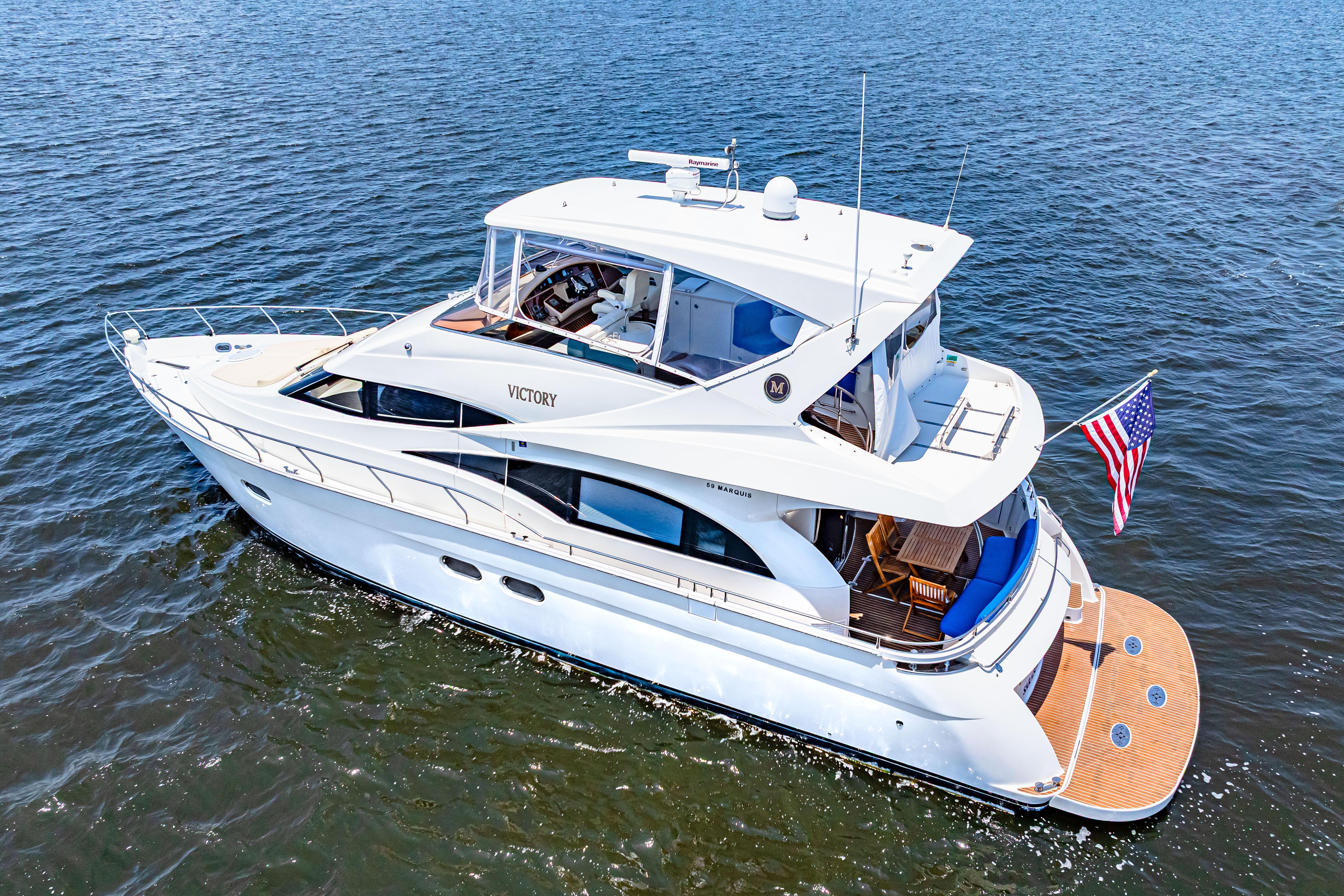 Marquis-59 2005-Victory FL-US-2005 Marquis 59 yacht cruising on open water with American flag displayed.-9773566 | Thumbnail