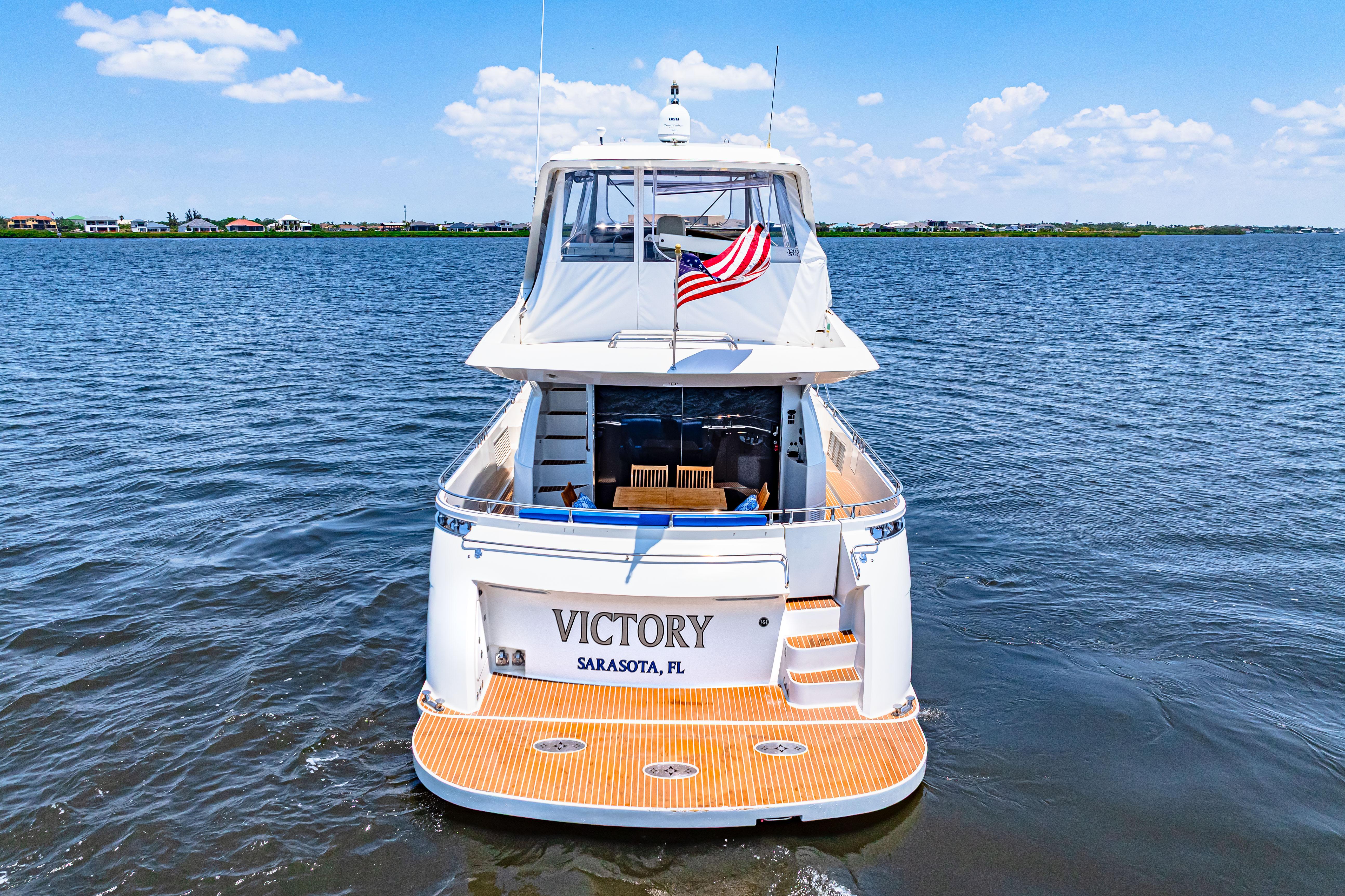 Marquis-59 2005-Victory FL-US-2005 Marquis 59 yacht named Victory on open water, rear view with American flag.-9773566 | Thumbnail