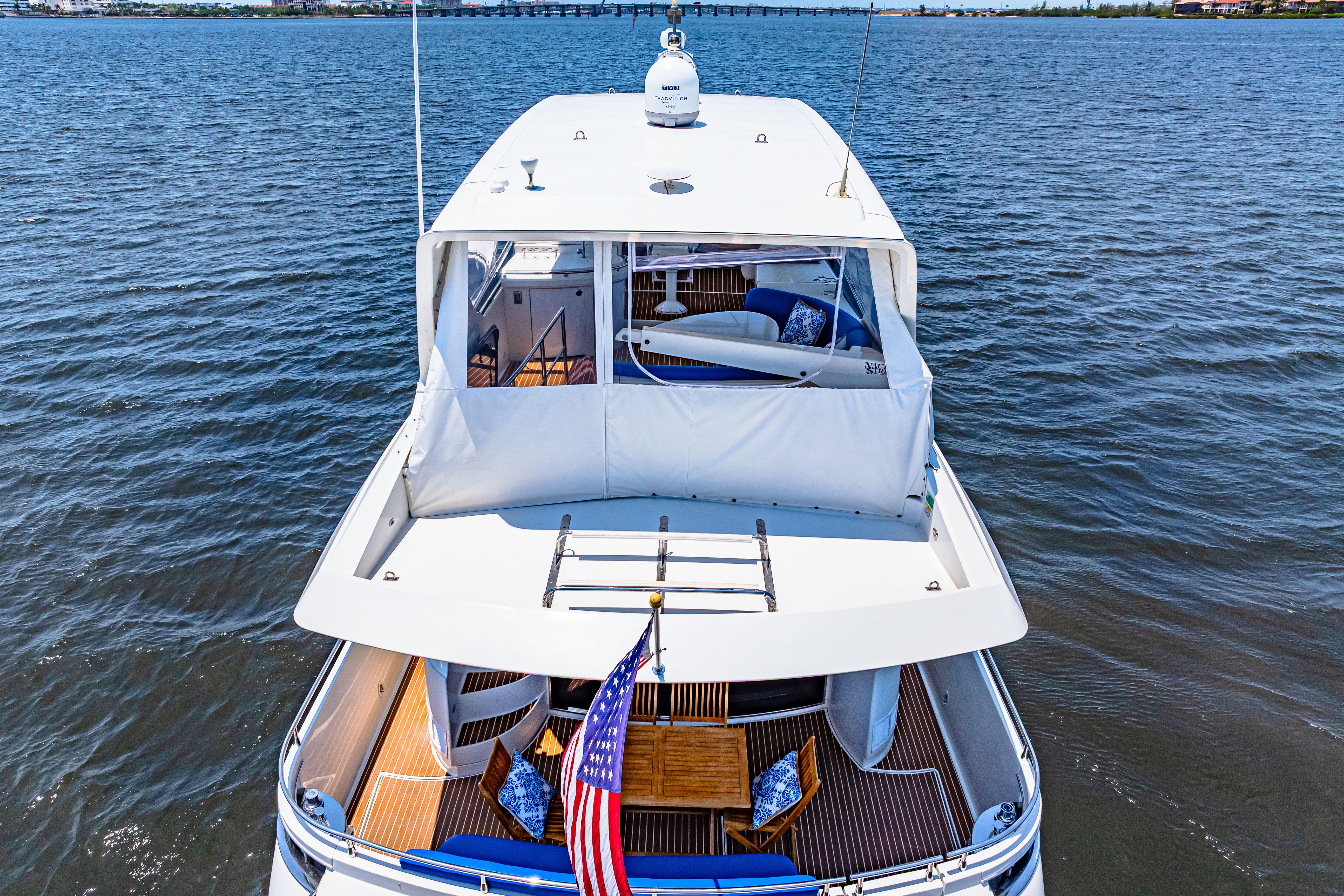 Marquis-59 2005-Victory FL-US-Luxury 2005 Marquis 59 yacht on open water, featuring spacious deck and American flag.-9773566 | Thumbnail