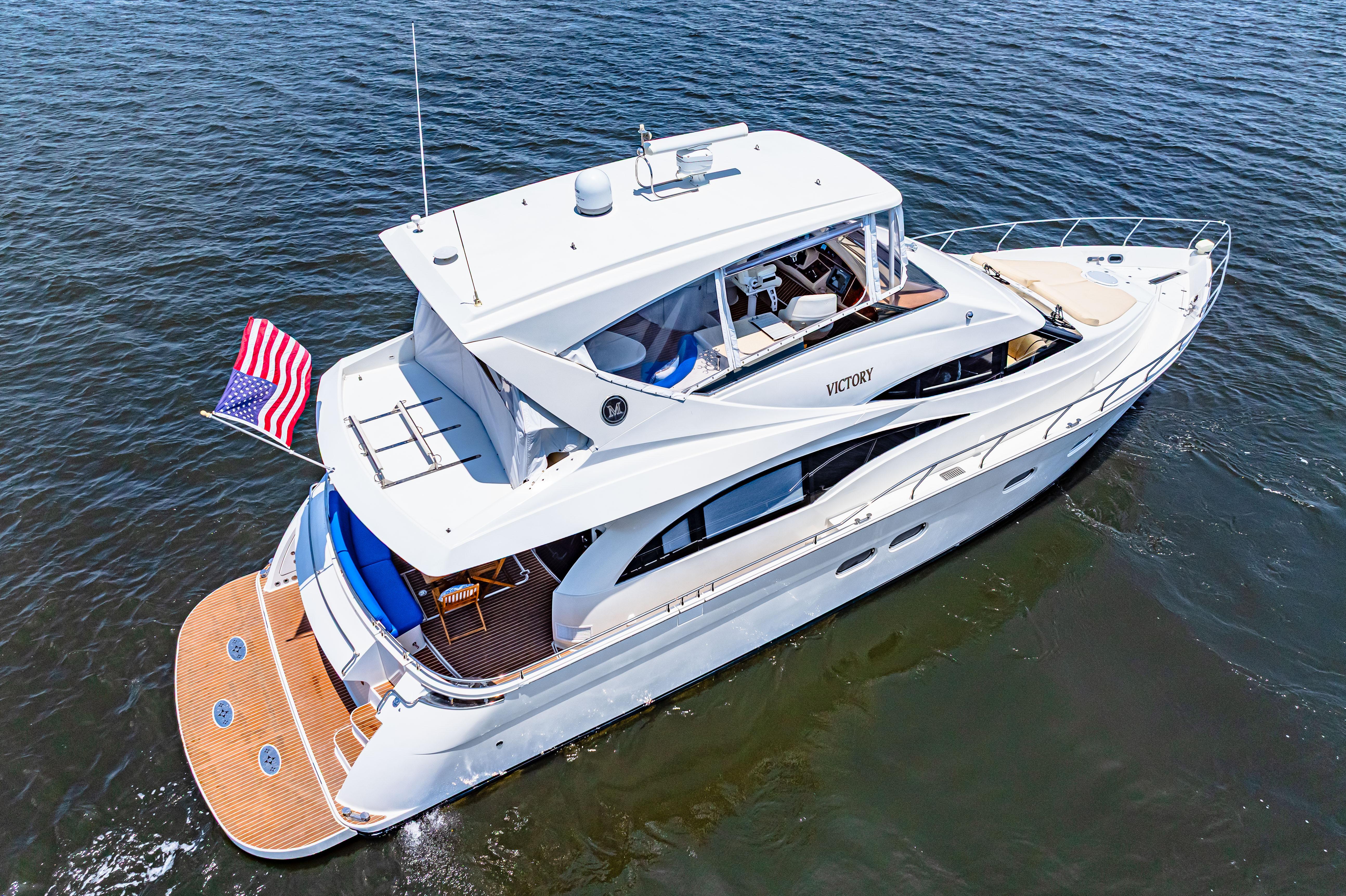 Marquis-59 2005-Victory FL-US-Luxury 2005 Marquis 59 yacht cruising on open water with American flag.-9773566 | Thumbnail