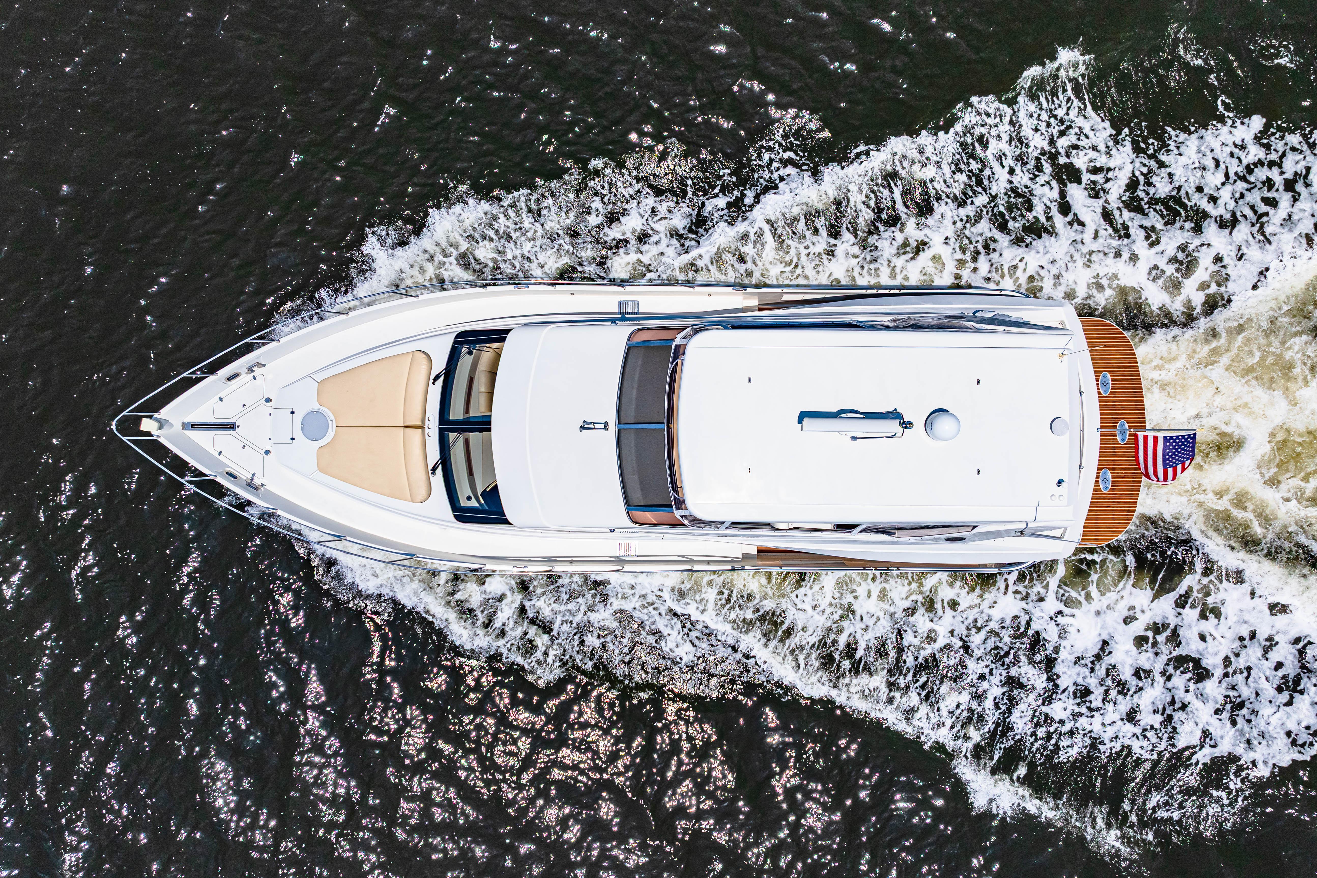Marquis-59 2005-Victory FL-US-Aerial view of 2005 Marquis 59 yacht cruising on water with American flag.-9773566 | Thumbnail