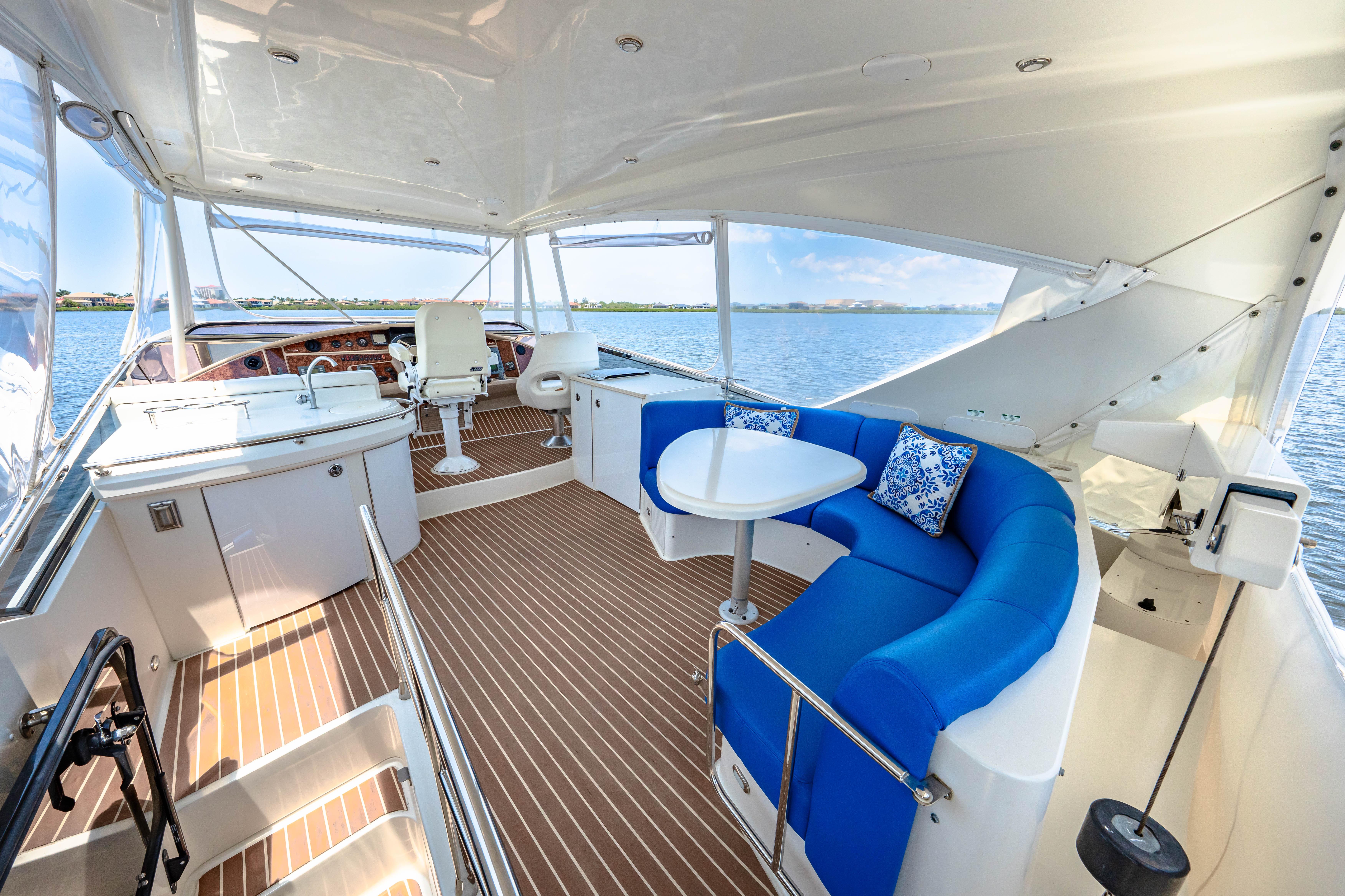 Marquis-59 2005-Victory FL-US-Luxurious 2005 Marquis 59 yacht interior with blue seating and scenic water view.-9773566 | Thumbnail
