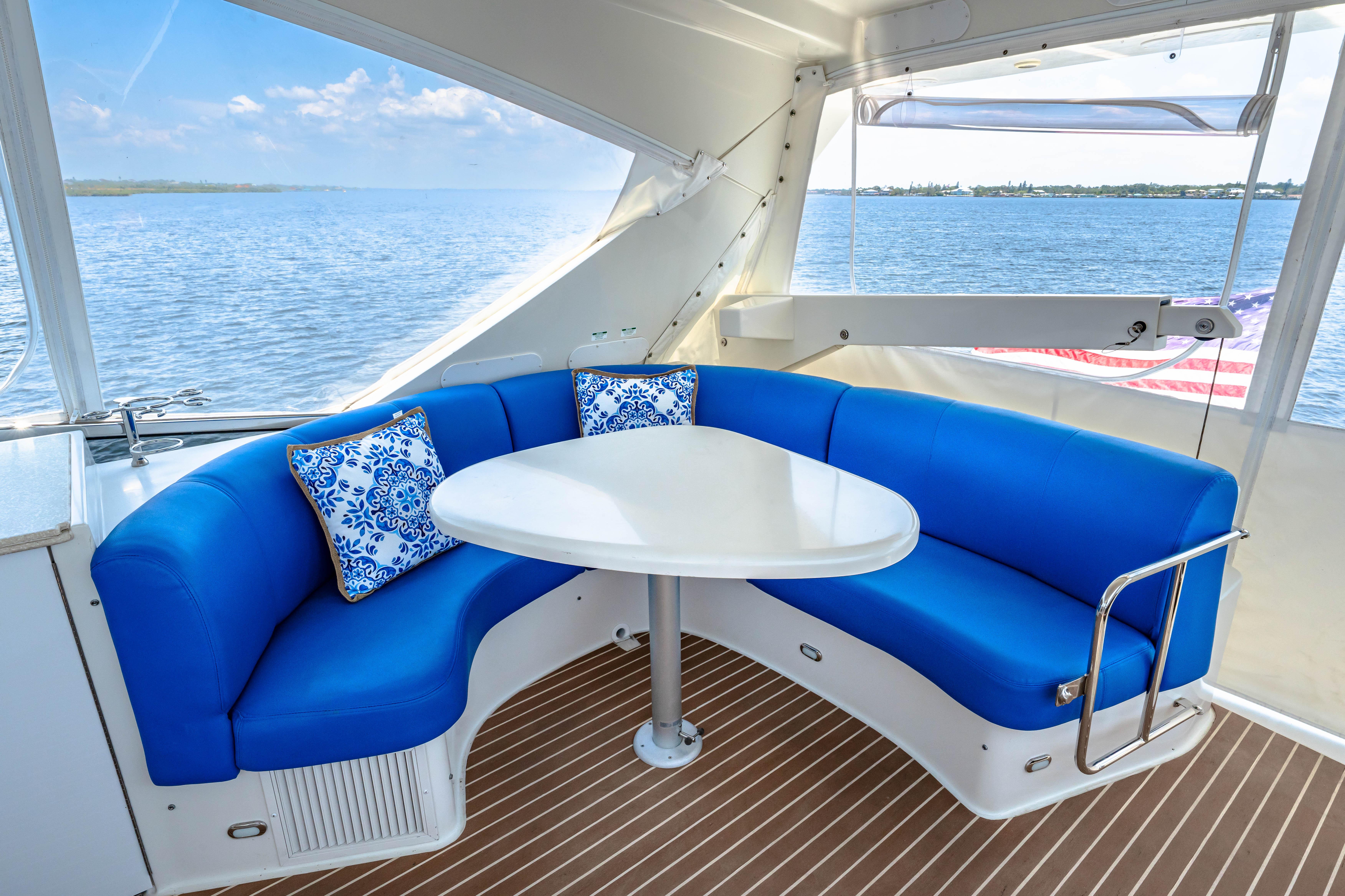 Marquis-59 2005-Victory FL-US-2005 Marquis 59 yacht interior with blue seating, white table, and ocean view.-9773566 | Thumbnail