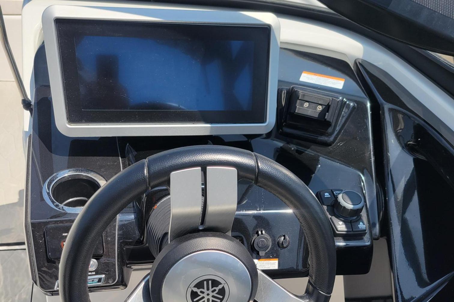 2021 Yamaha Boats 252XE dashboard with steering wheel and touchscreen display.