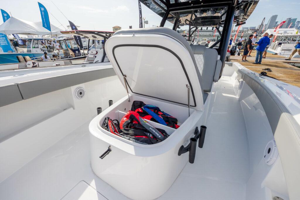 Front Runner-39 CC Custom 2026 -FL-US-2024 Front Runner 39 CC Custom boat with open storage compartment at a boat show.-9053590 | Thumbnail