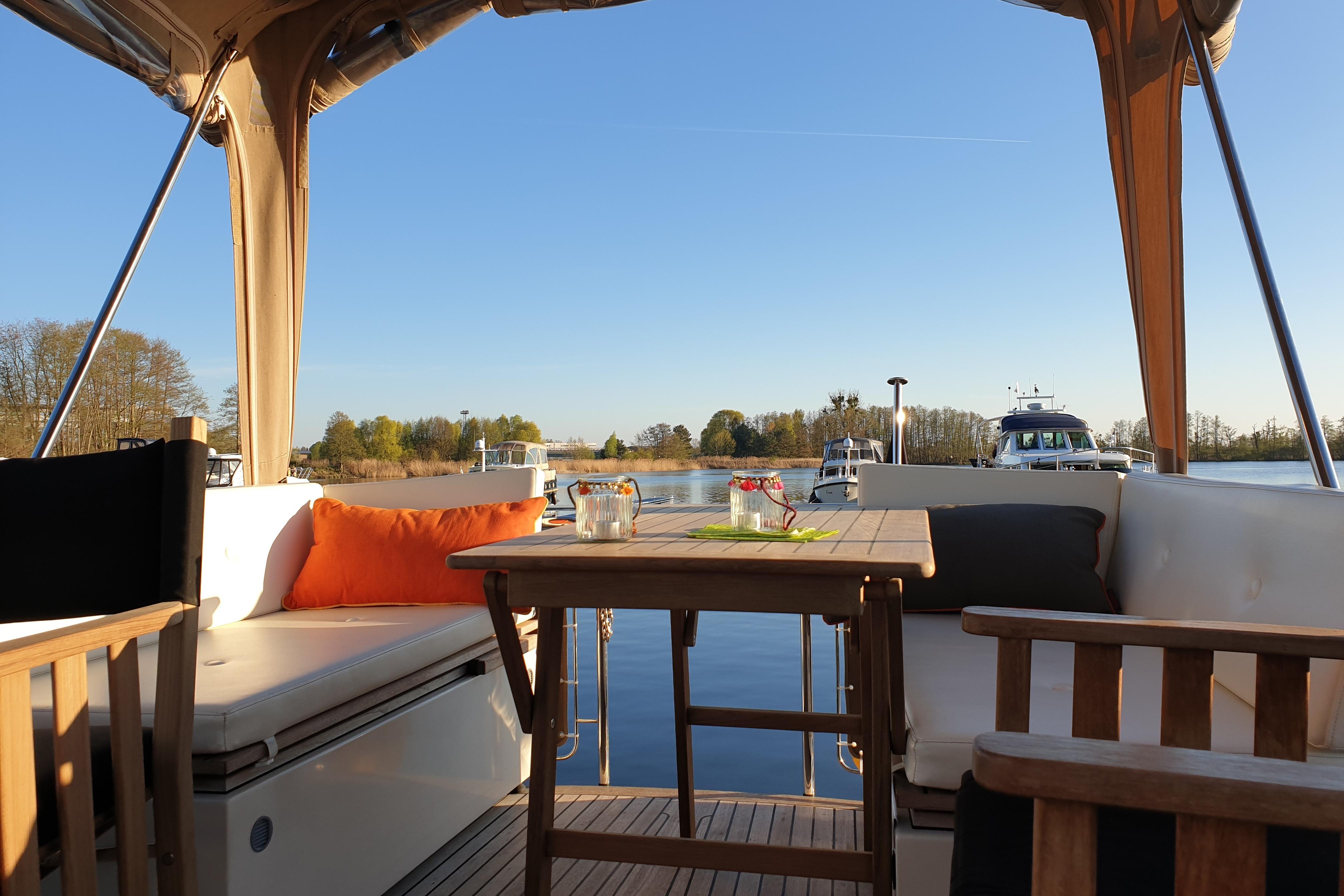 Linssen Yachts 2014 Sturdy 36 AC interior with scenic water view, cozy seating, and table.