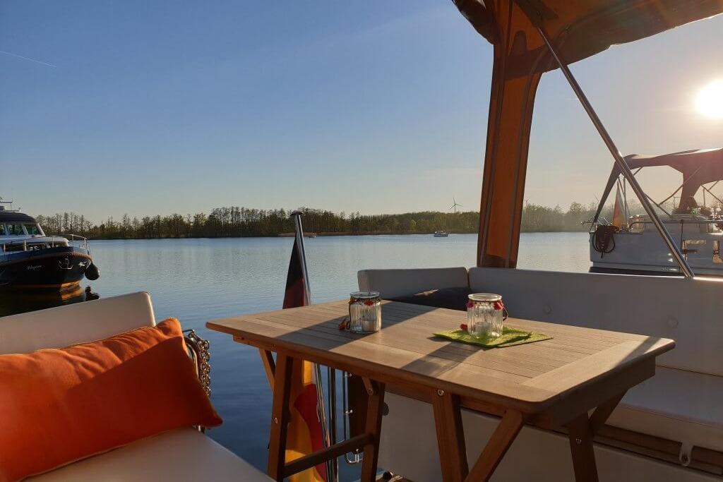 Linssen Yachts 2014 Sturdy 36 AC, serene lake view, cozy deck seating, sunset ambiance.