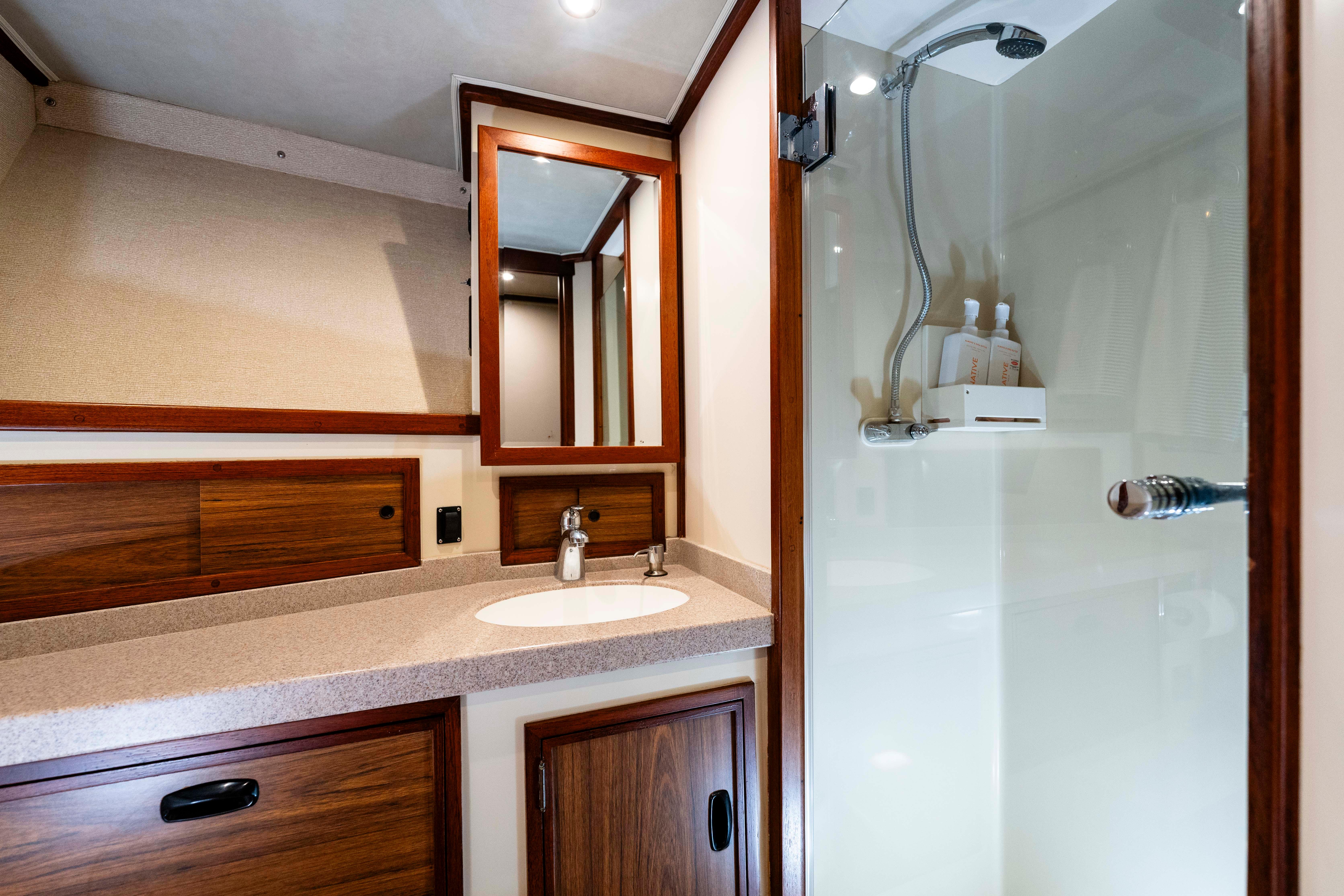 Pacifica-50 Convertible 1983-Bull Pen CA-US-1983 Pacifica 50 Convertible yacht bathroom with wood accents and modern fixtures.-9793604 | Thumbnail