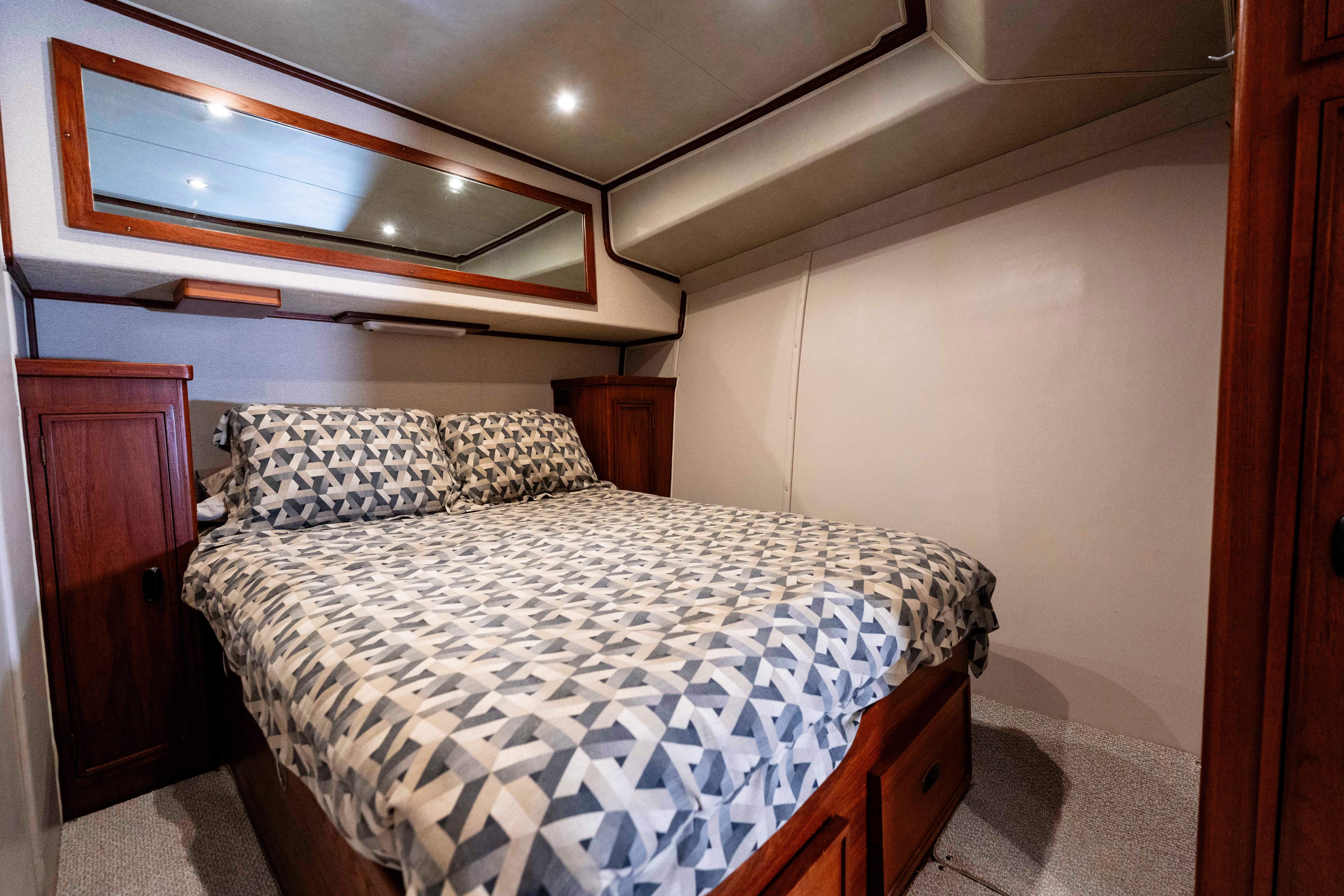 Pacifica-50 Convertible 1983-Bull Pen CA-US-Cozy bedroom in 1983 Pacifica 50 Convertible yacht with geometric bedding and wooden accents.-9793604 | Thumbnail