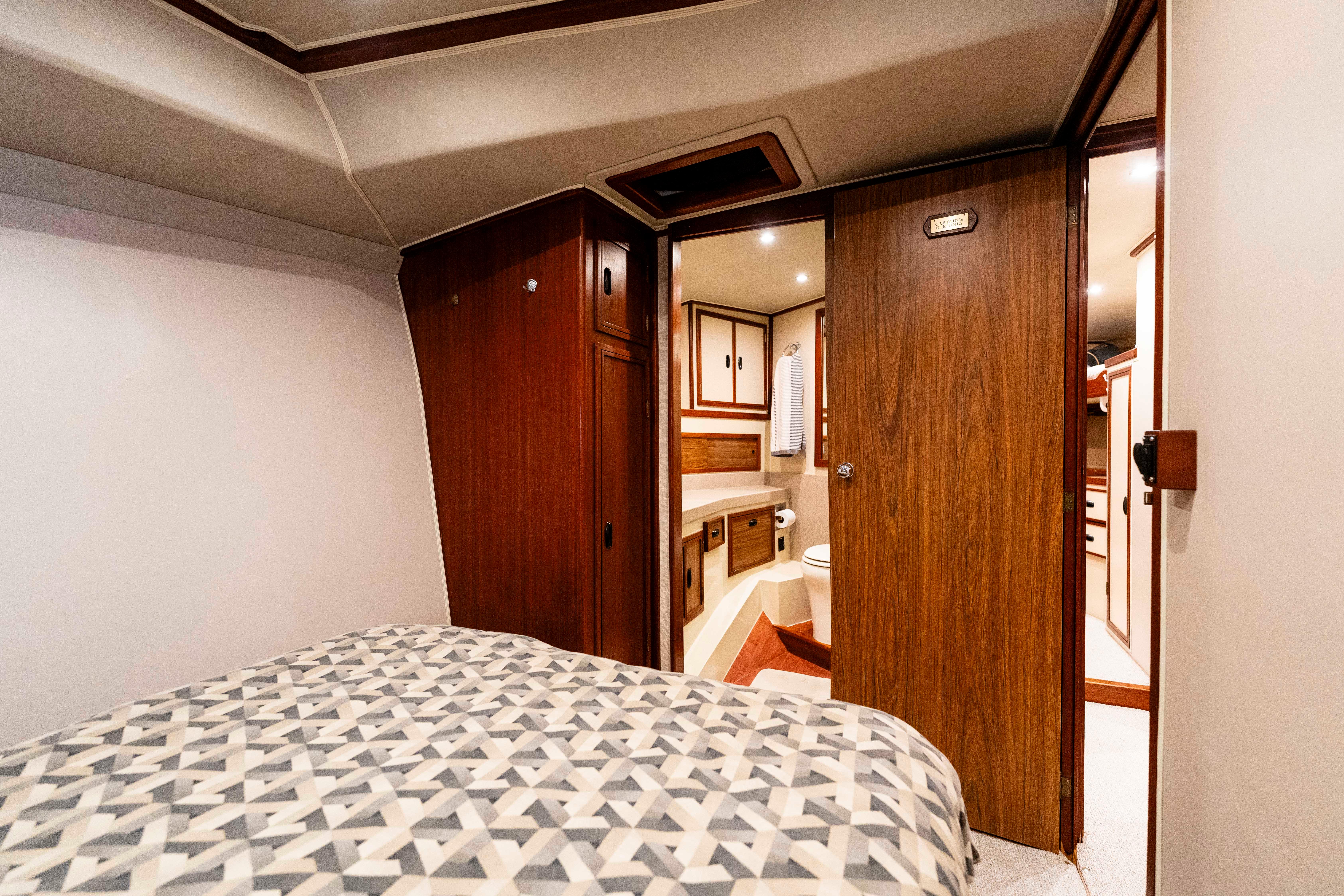 Pacifica-50 Convertible 1983-Bull Pen CA-US-1983 Pacifica 50 Convertible yacht interior with cozy bedroom and wooden cabinetry.-9793604 | Thumbnail