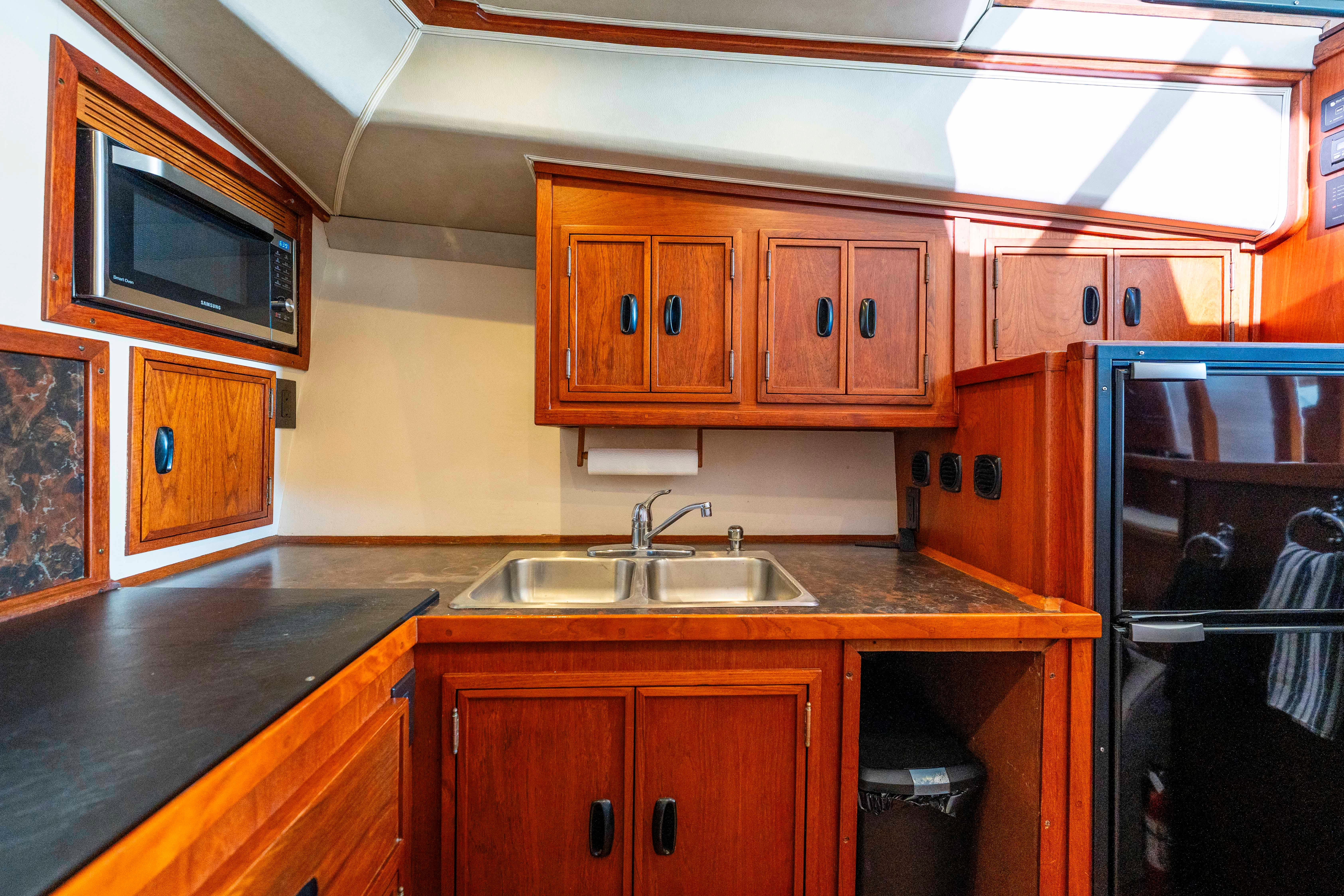 Pacifica-50 Convertible 1983-Bull Pen CA-US-1983 Pacifica 50 Convertible yacht kitchen with wooden cabinets and modern appliances.-9793604 | Thumbnail
