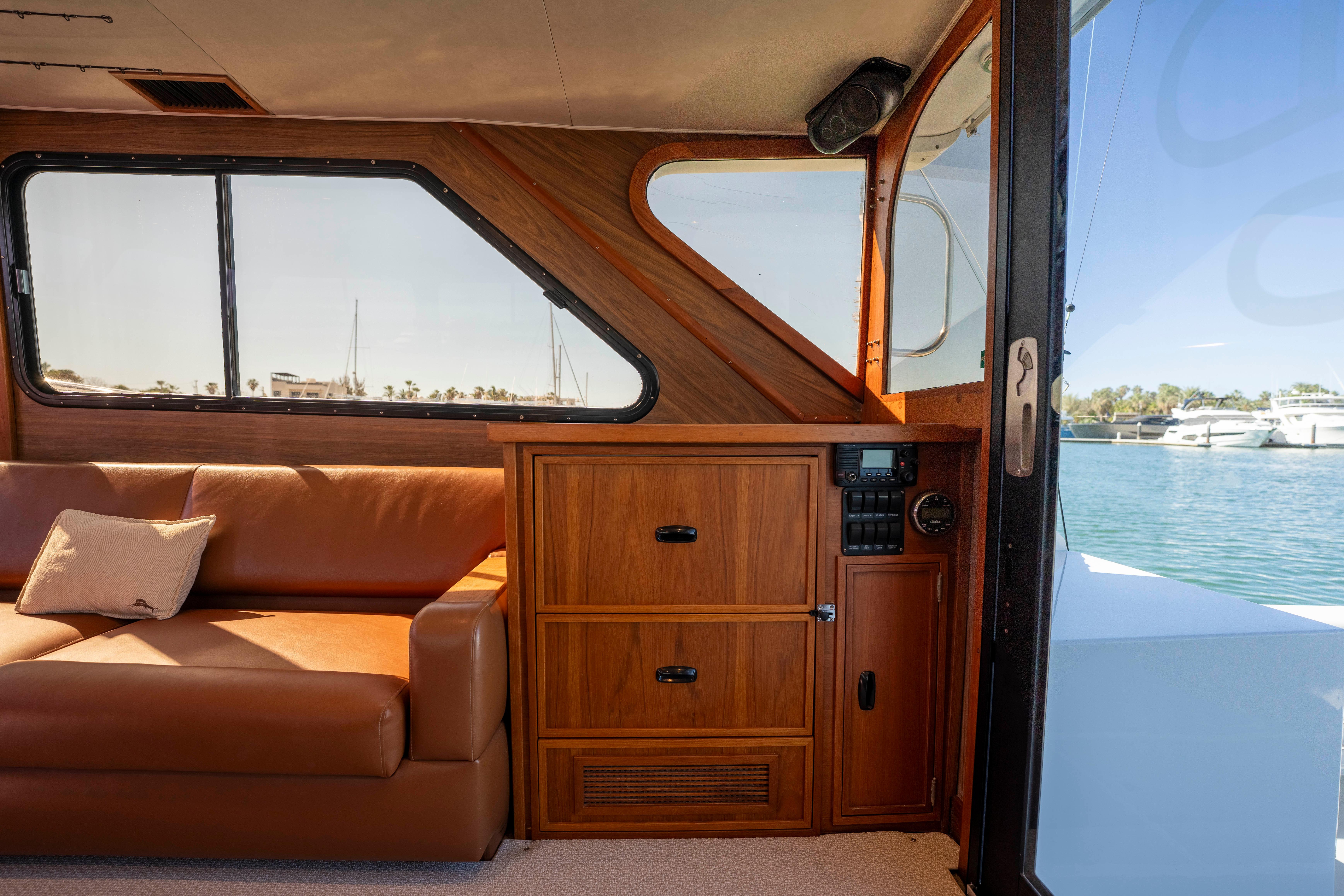 Pacifica-50 Convertible 1983-Bull Pen CA-US-Interior of 1983 Pacifica 50 Convertible yacht with leather sofa and wooden cabinetry.-9793604 | Thumbnail