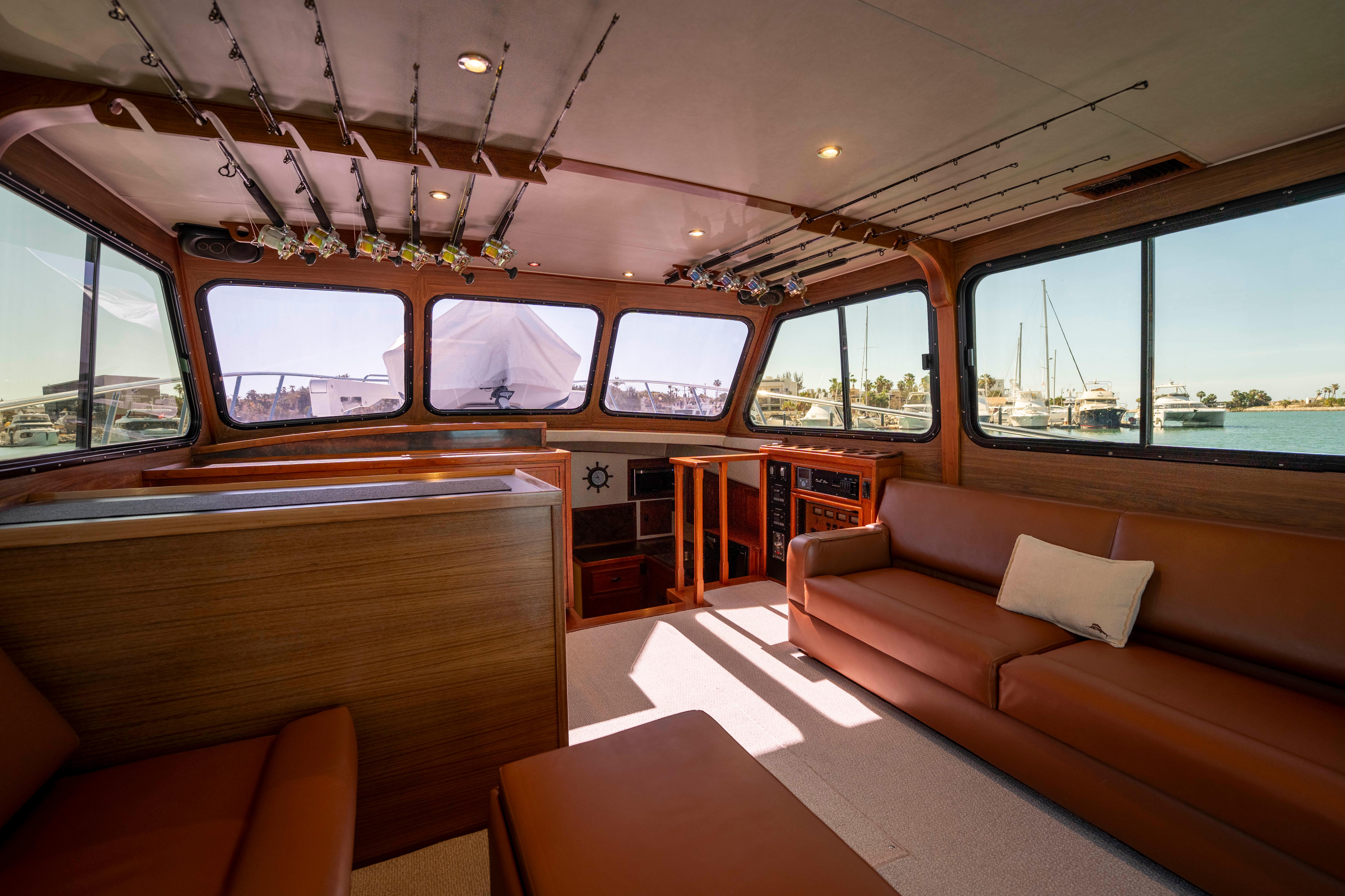 Pacifica-50 Convertible 1983-Bull Pen CA-US-Interior of 1983 Pacifica 50 Convertible yacht with brown seating and large windows.-9793604 | Thumbnail