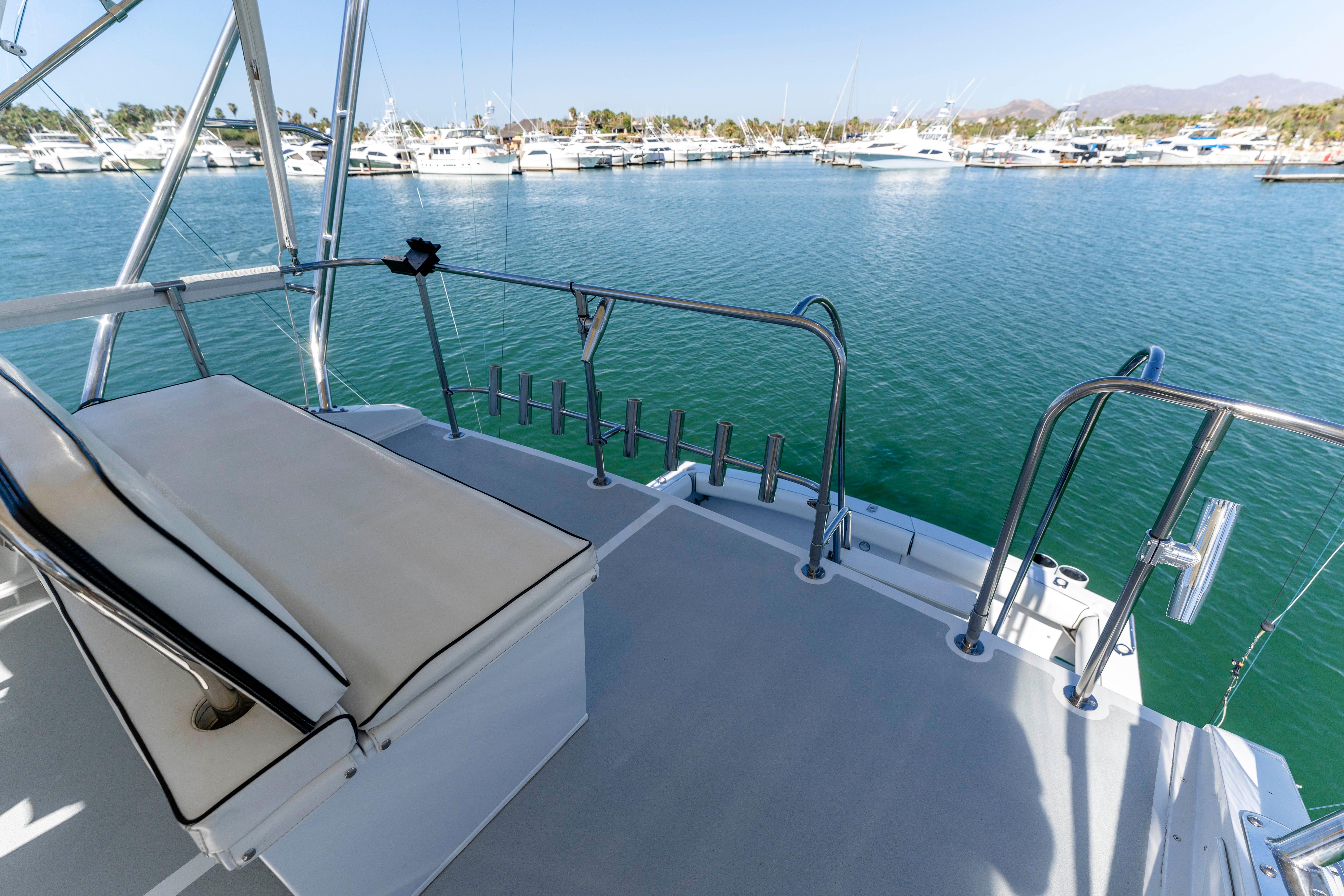 Pacifica-50 Convertible 1983-Bull Pen CA-US-1983 Pacifica 50 Convertible boat deck overlooking marina with clear blue water.-9793604 | Thumbnail