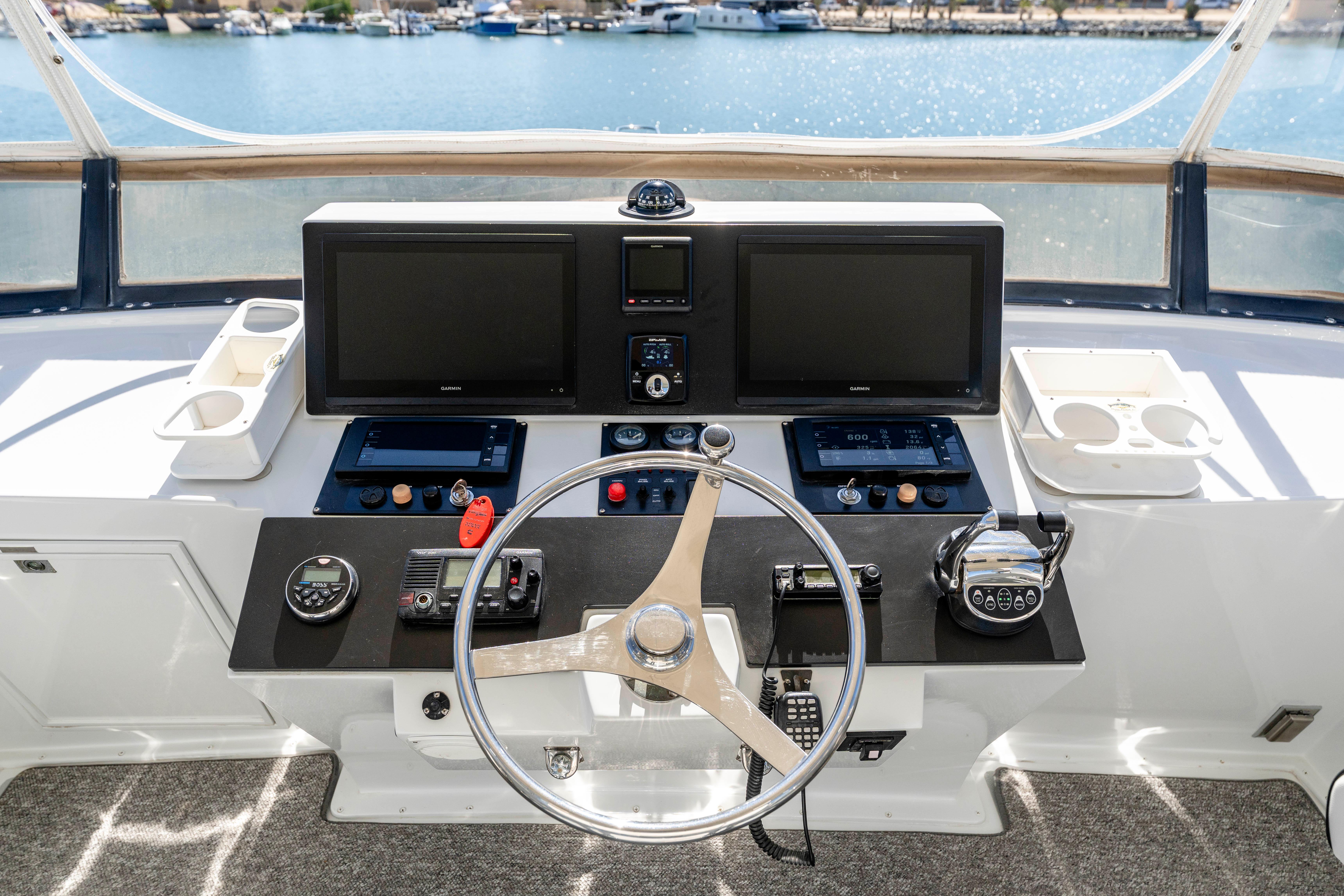 Pacifica-50 Convertible 1983-Bull Pen CA-US-1983 Pacifica 50 Convertible yacht helm with dual screens and steering wheel, overlooking marina.-9793604 | Thumbnail