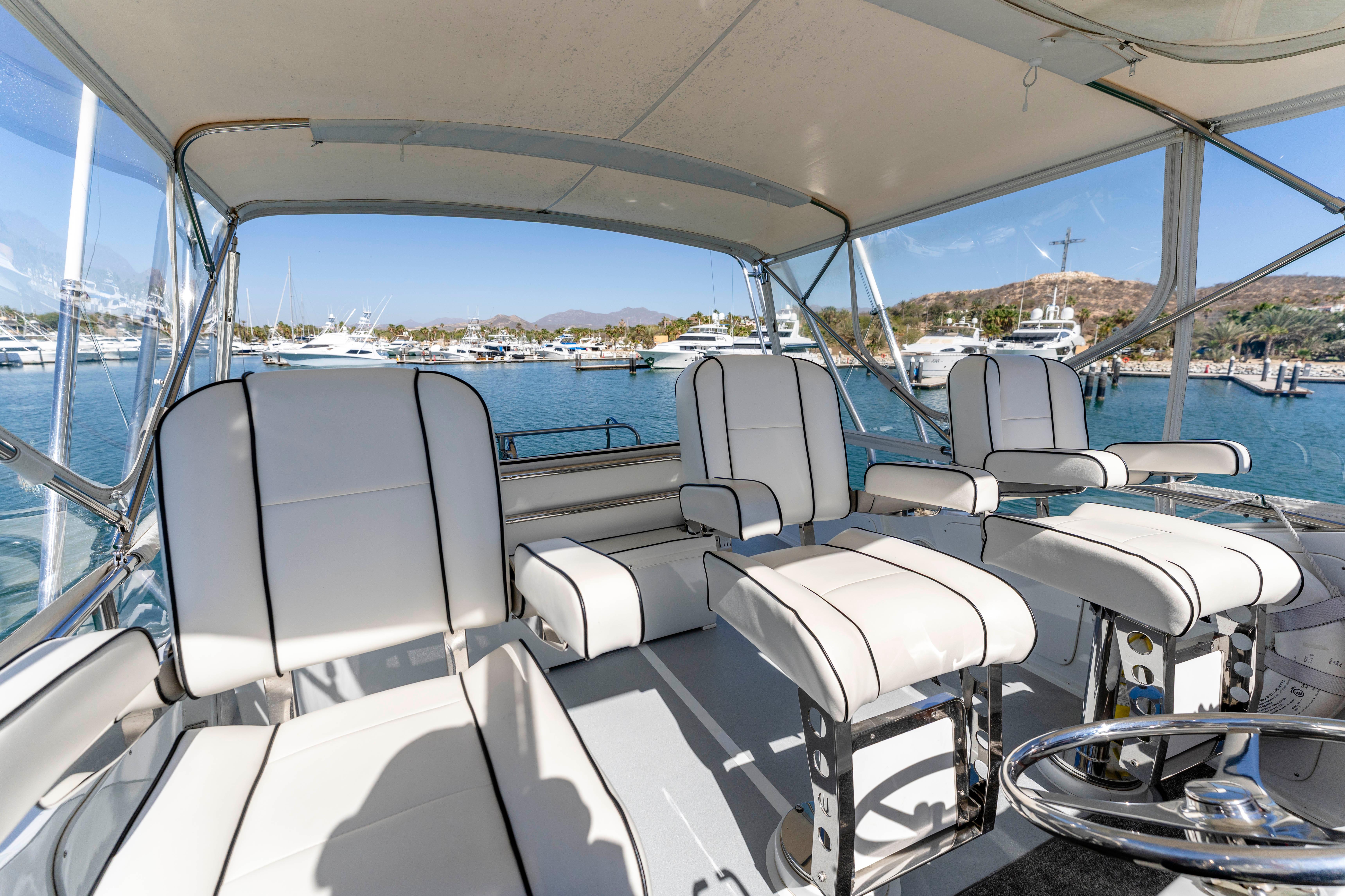 Pacifica-50 Convertible 1983-Bull Pen CA-US-1983 Pacifica 50 Convertible yacht interior with white seating, docked in a sunny marina.-9793604 | Thumbnail