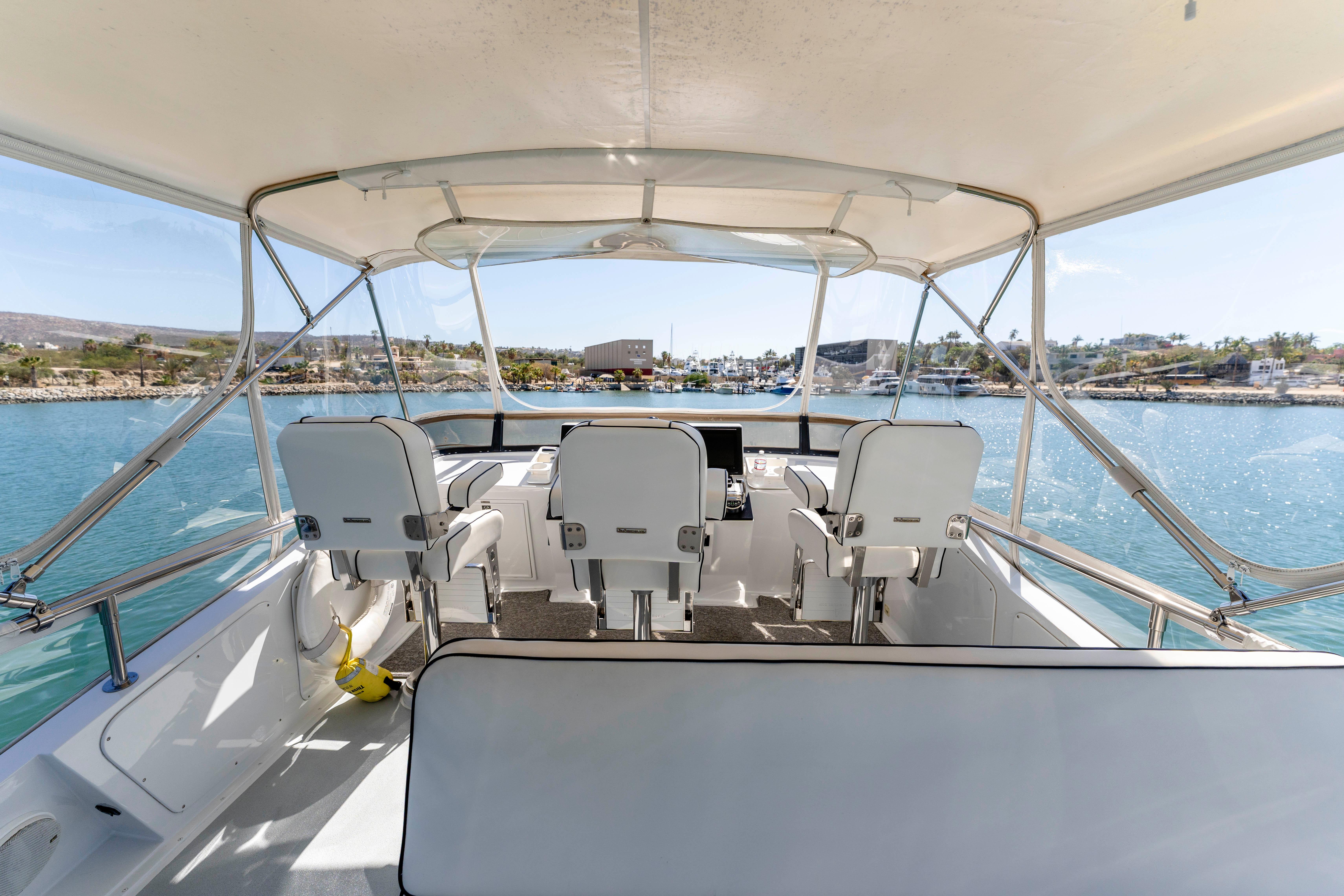 Pacifica-50 Convertible 1983-Bull Pen CA-US-1983 Pacifica 50 Convertible yacht interior with helm, overlooking marina and blue waters.-9793604 | Thumbnail