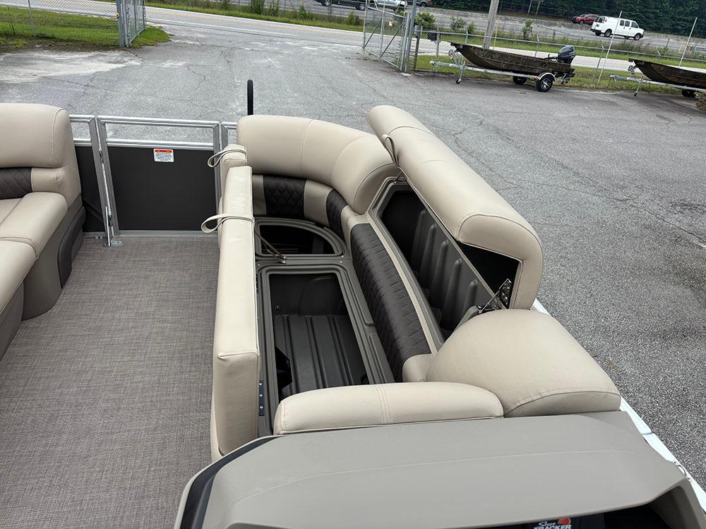 2025 Sun Tracker Party Barge 20 DLX interior with beige seating and storage compartments.