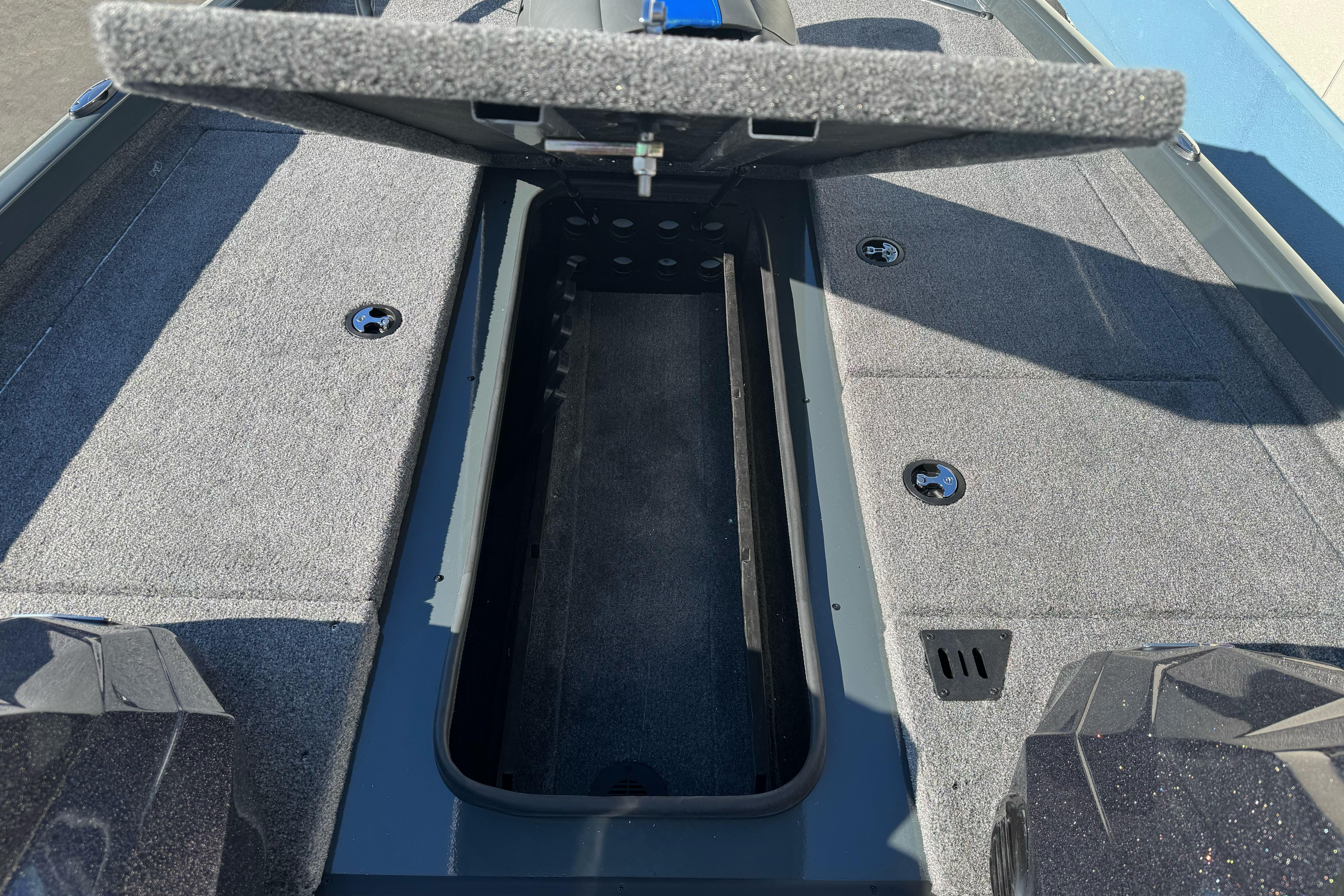 Open storage compartment in 2026 Ranger RT188P boat, showcasing interior design and carpeted surface.