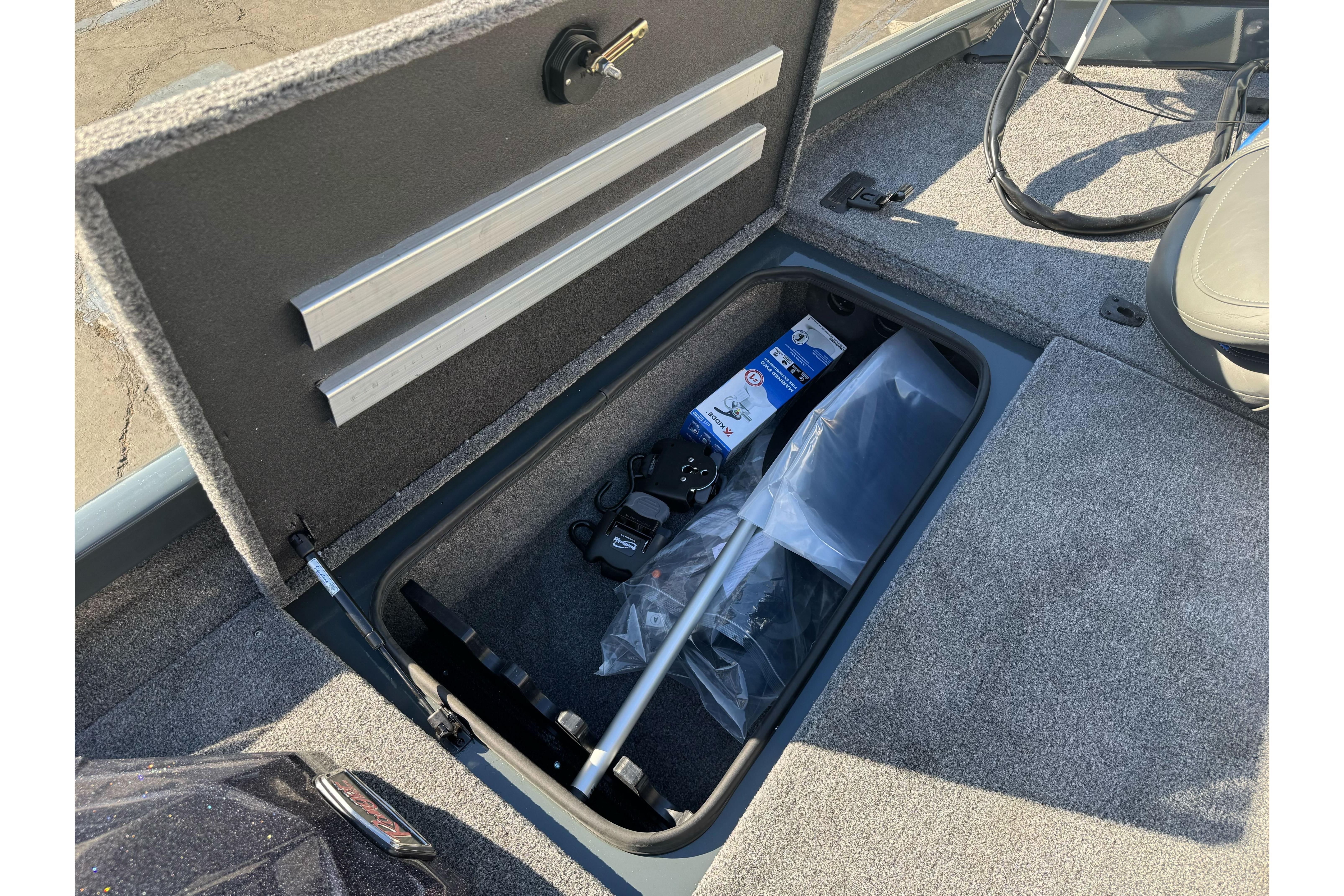 Open storage compartment in 2026 Ranger RT188P boat, showing equipment and accessories.