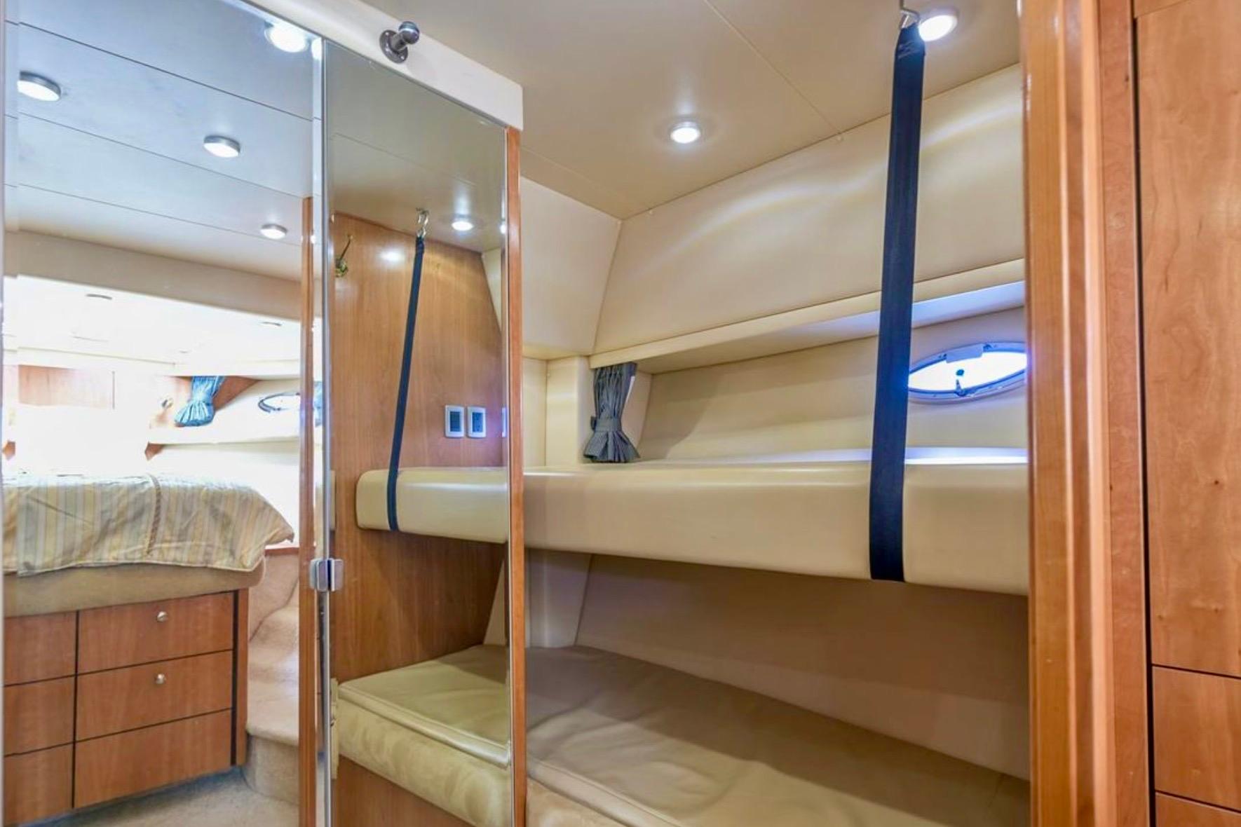 Interior of 2004 Meridian 490 Pilothouse with bunk beds and wooden cabinetry.