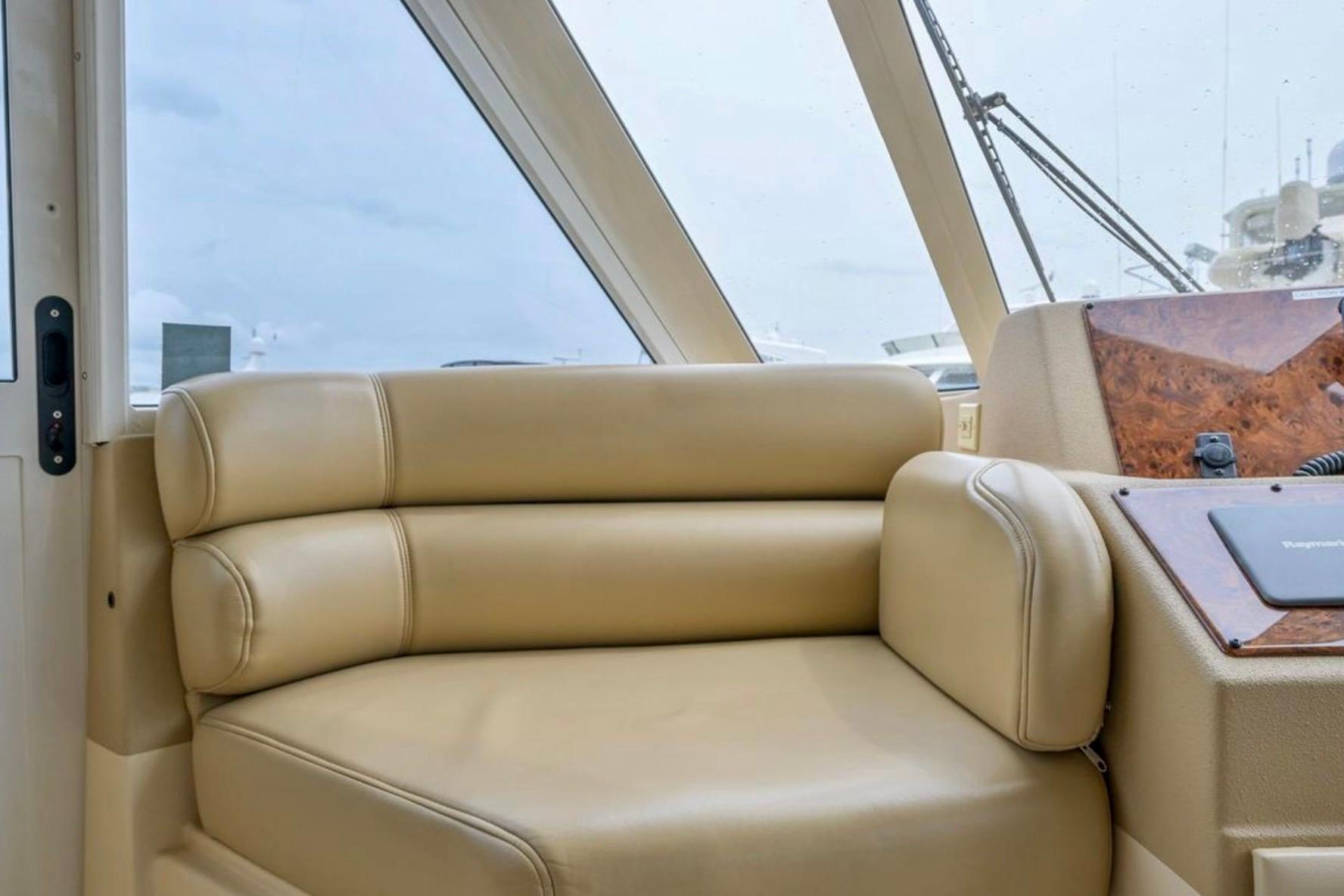 Luxurious beige seating in 2004 Meridian 490 Pilothouse yacht interior.