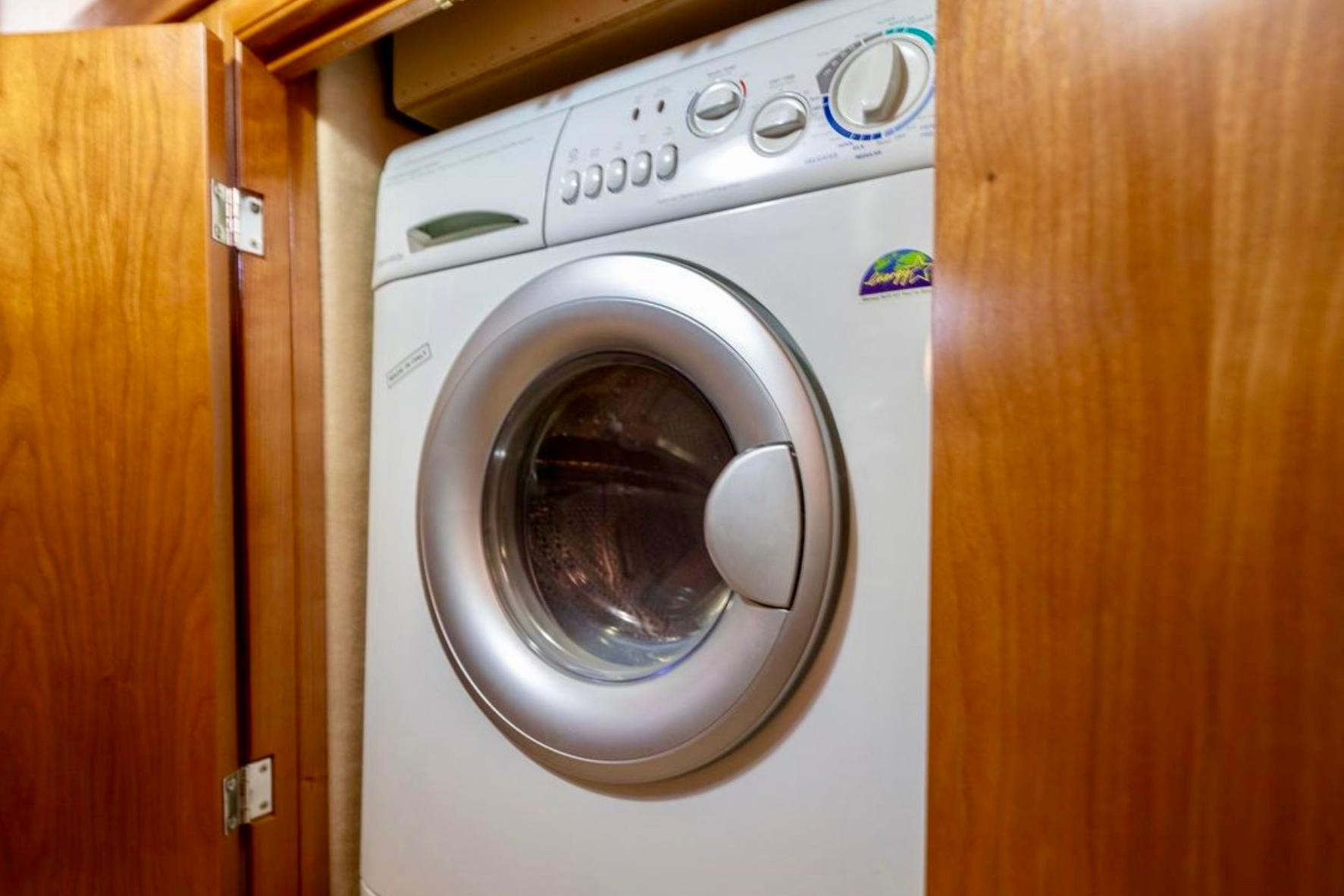 Washing machine inside 2004 Meridian 490 Pilothouse wooden cabinet.