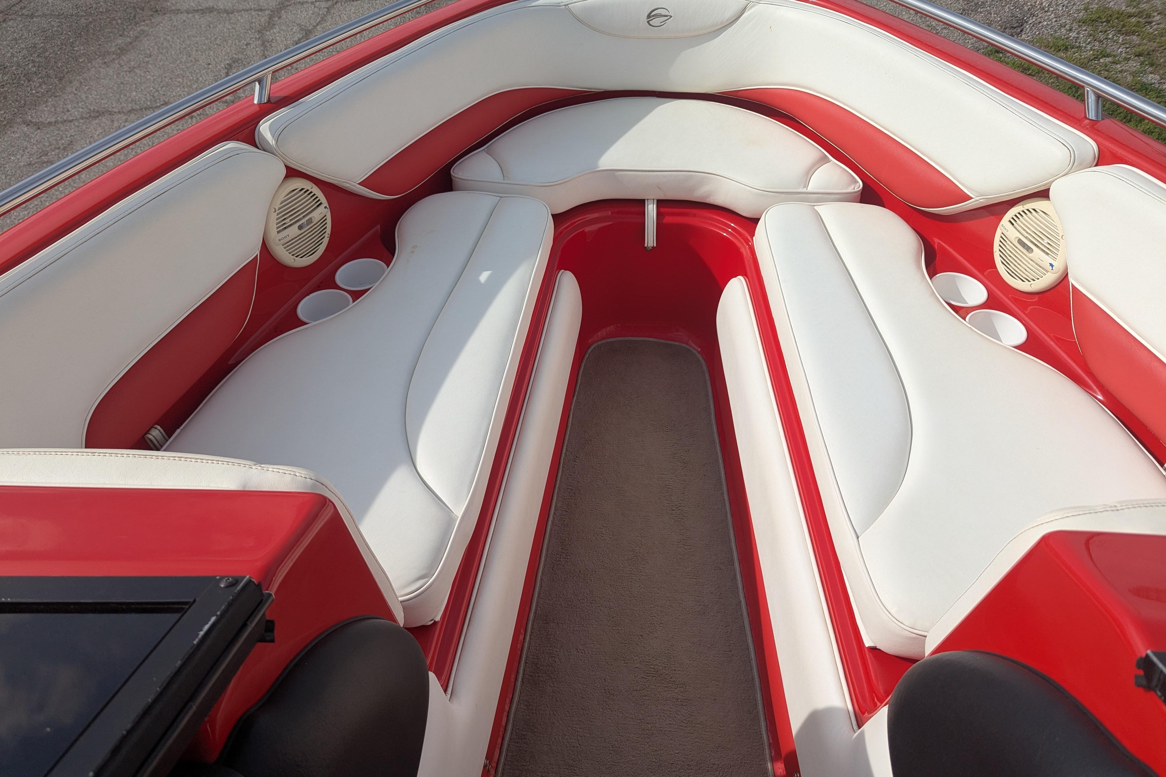 2004 Crownline 225 BR boat interior with red and white seating and cup holders.